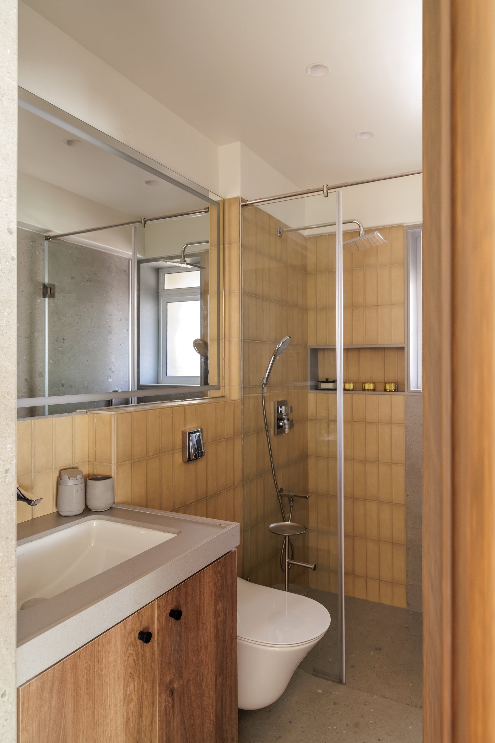 The second bathroom, lined floor-to-ceiling in stacked ochre tile