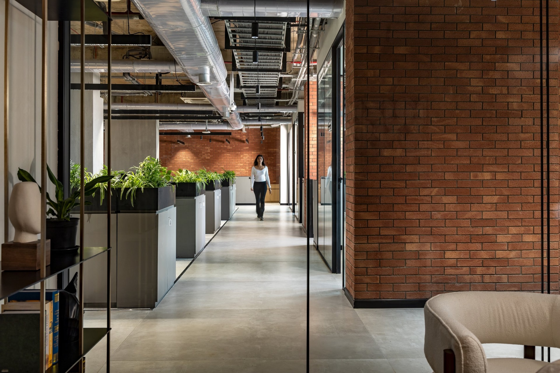 The internal street between workstations and cabins, edged with planters and brick