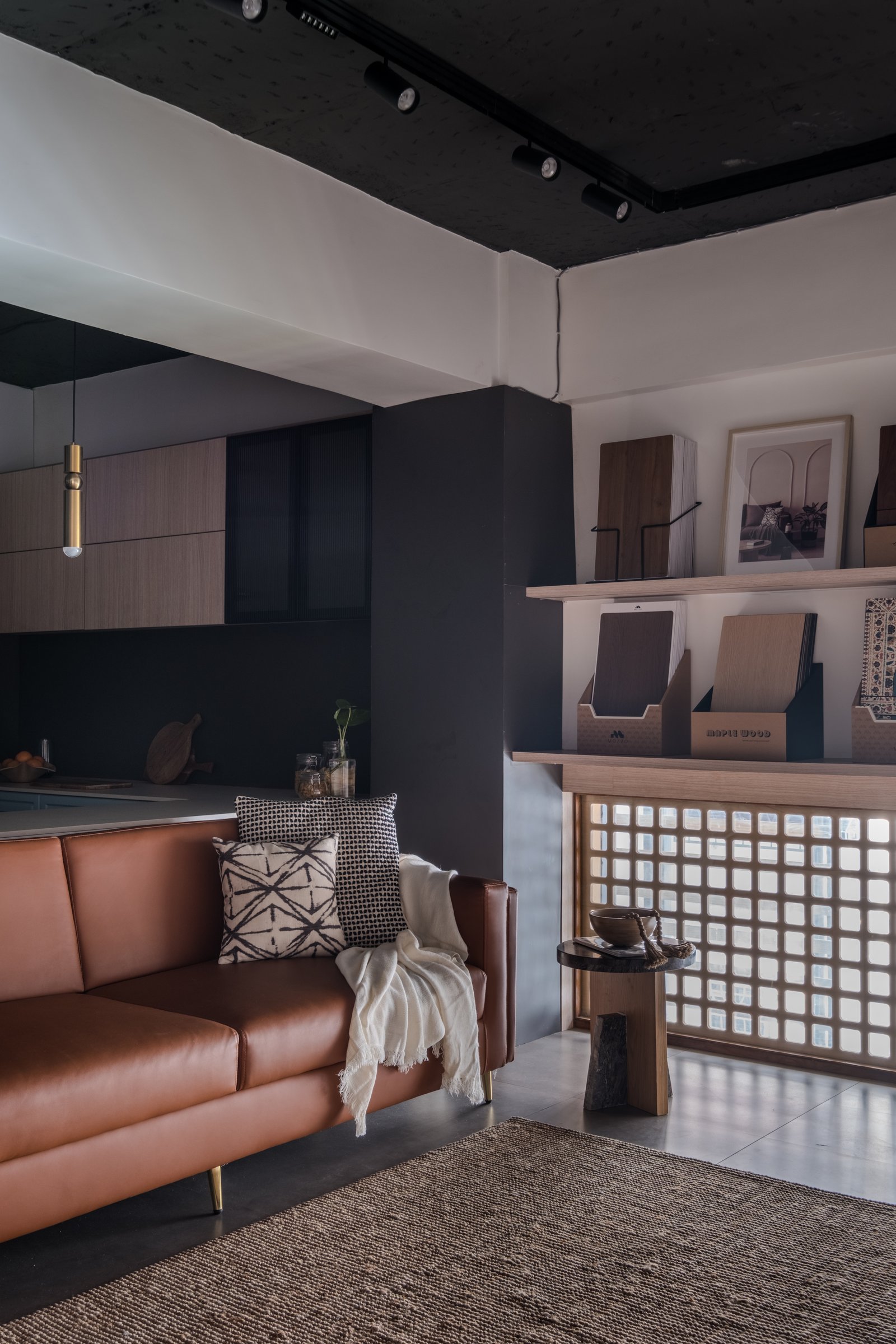 A lounge corner on the mezzanine extends the residential temperament, with a glass-block screen admitting diffused light into the low-lit zone