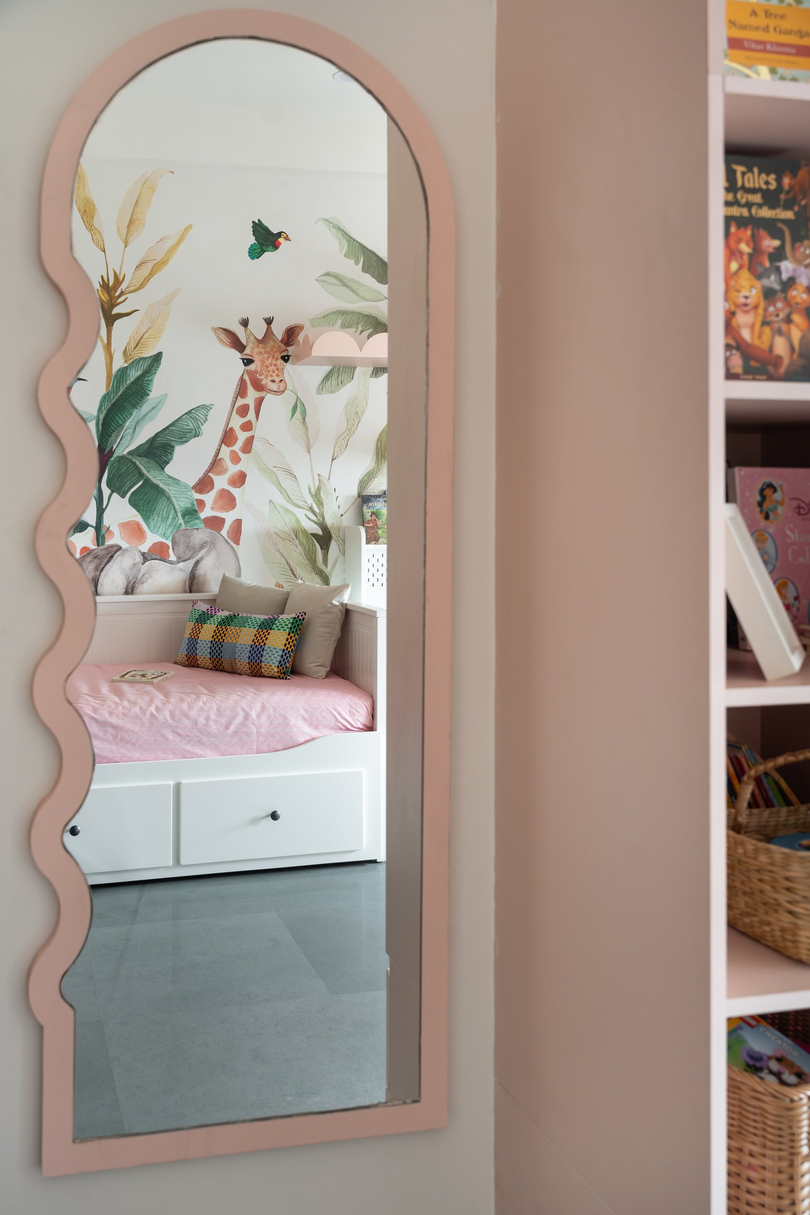 A wave-edged mirror reflects the mural back into the room, doubling its scale