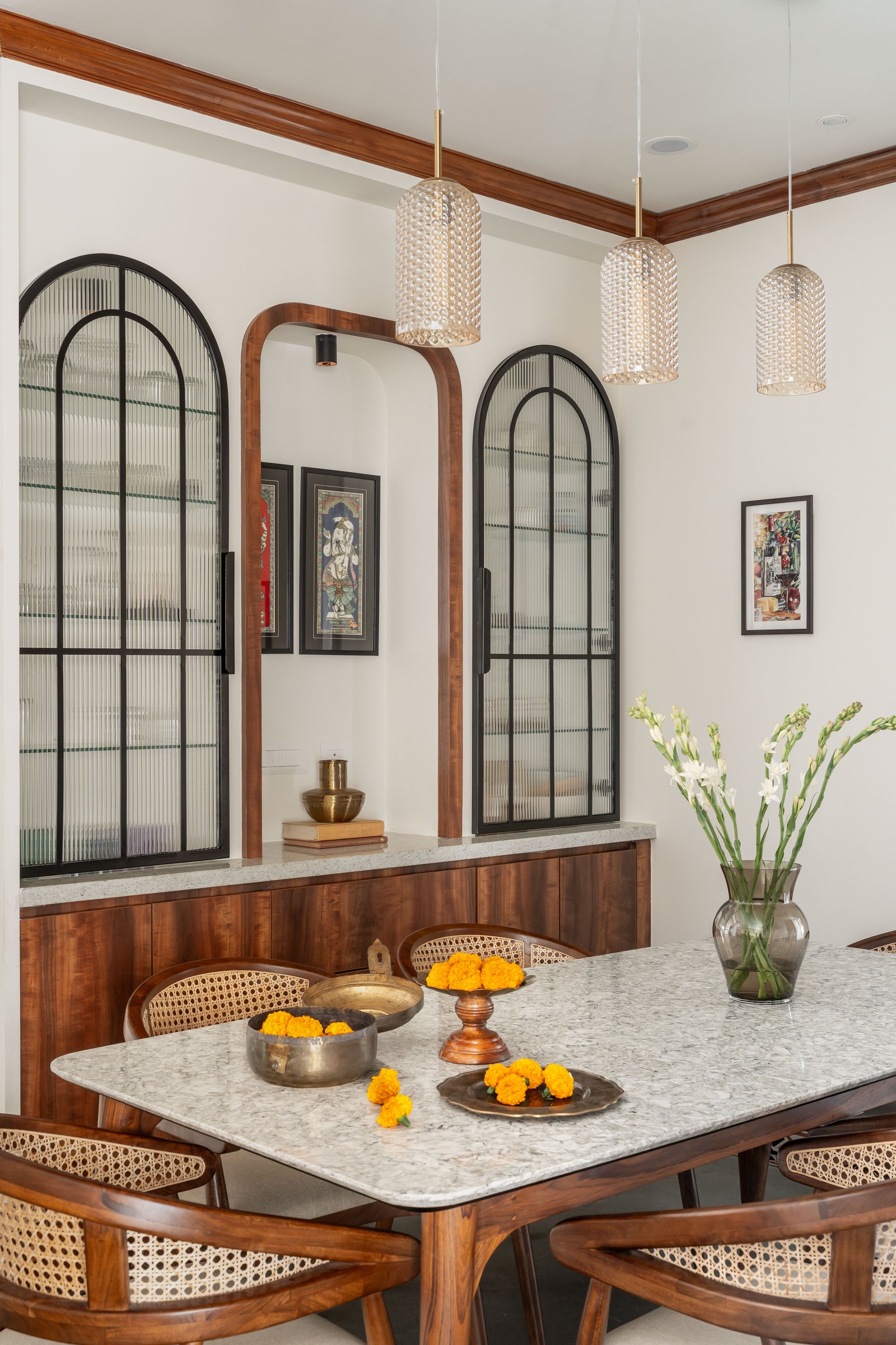 A closer view of the arched grilles and central teakwood doorway, where repetition becomes the home's spatial grammar