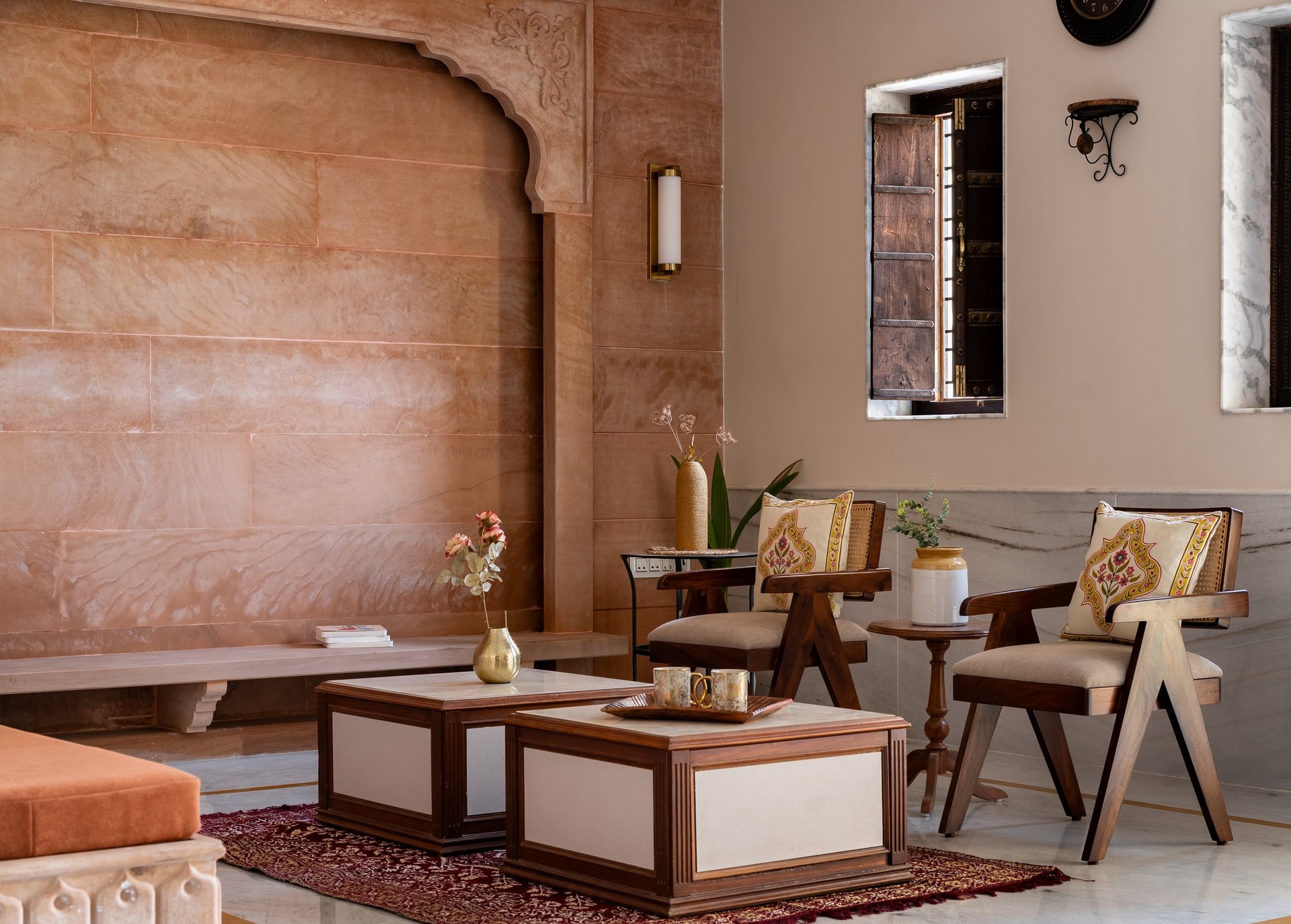 The sandstone wall in closer view, its horizontal coursing and carved cusped arch left to speak without ornamentation