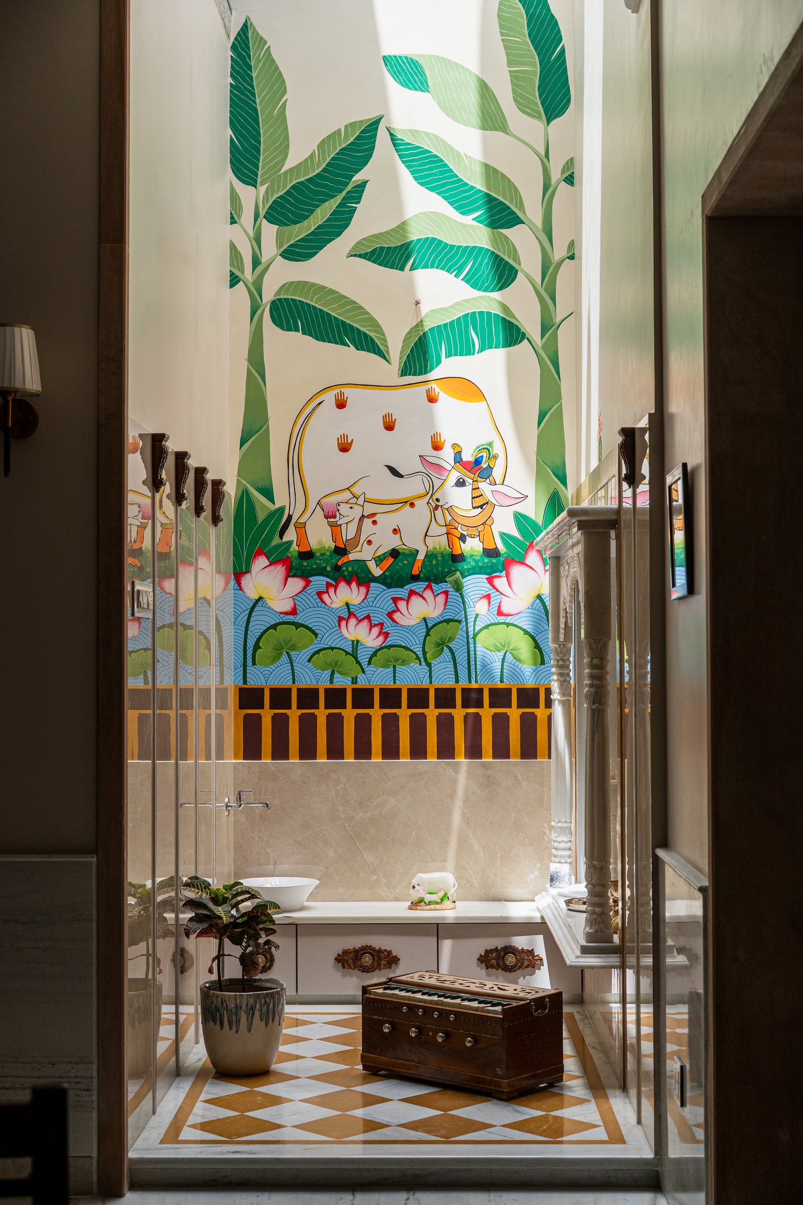 The pooja room: a hand-painted mural of banana fronds, sacred cows and lotus blooms designed exclusively for the residence