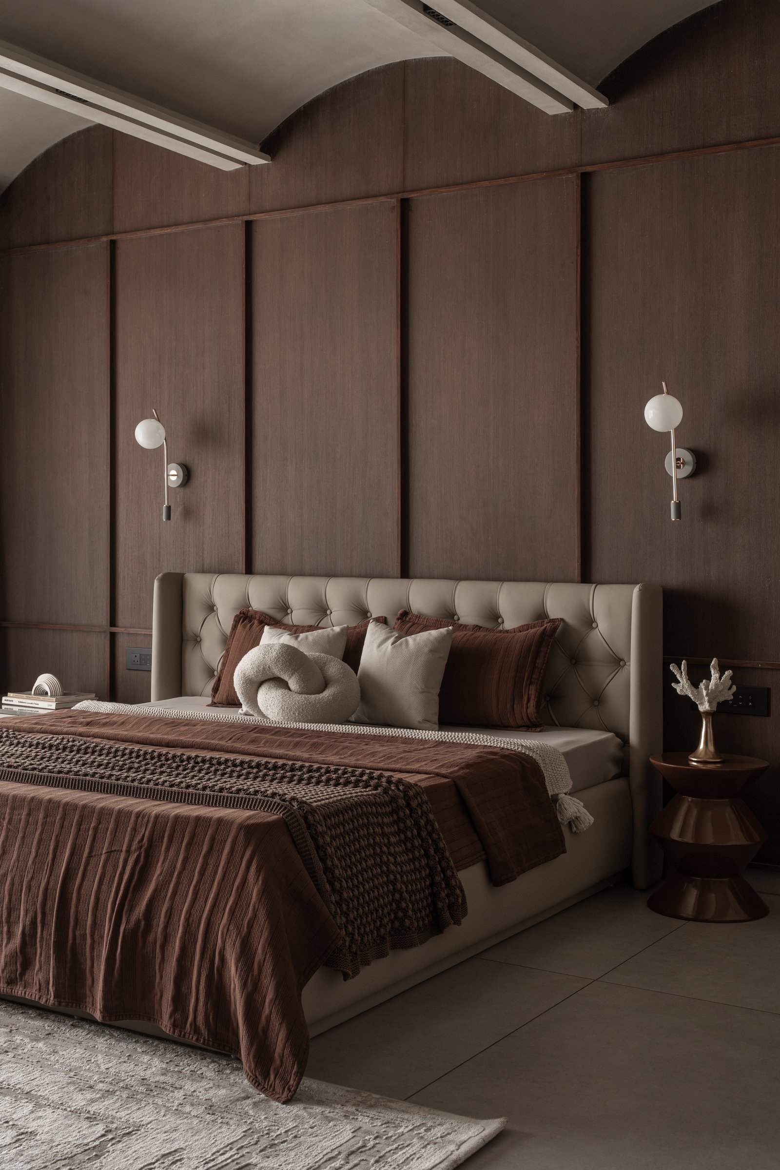The second bedroom, where a vaulted ceiling of three plaster arches sits above dark wood paneling