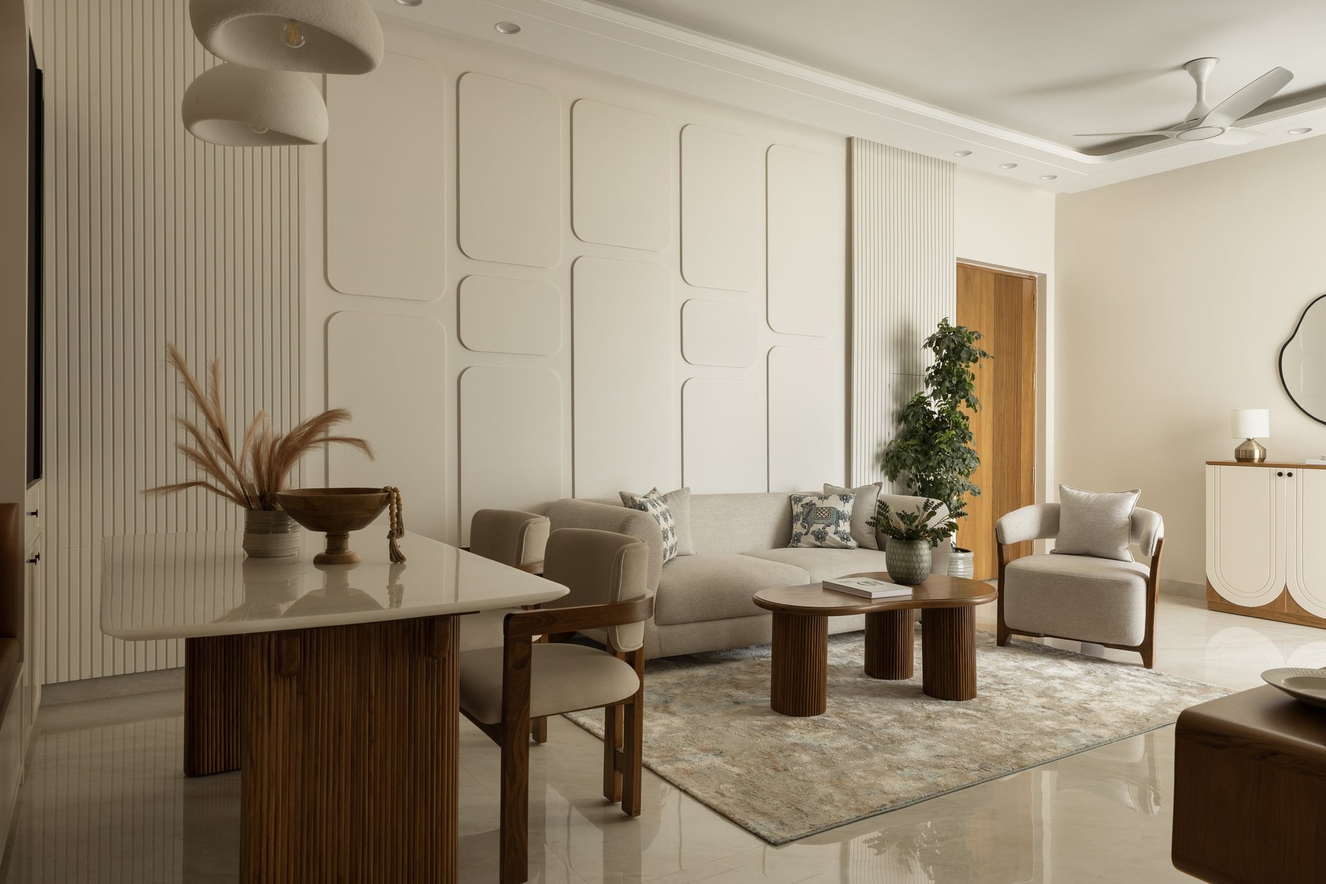The signature wall of soft-edged rectangular mouldings, the apartment's closest gesture toward ornament