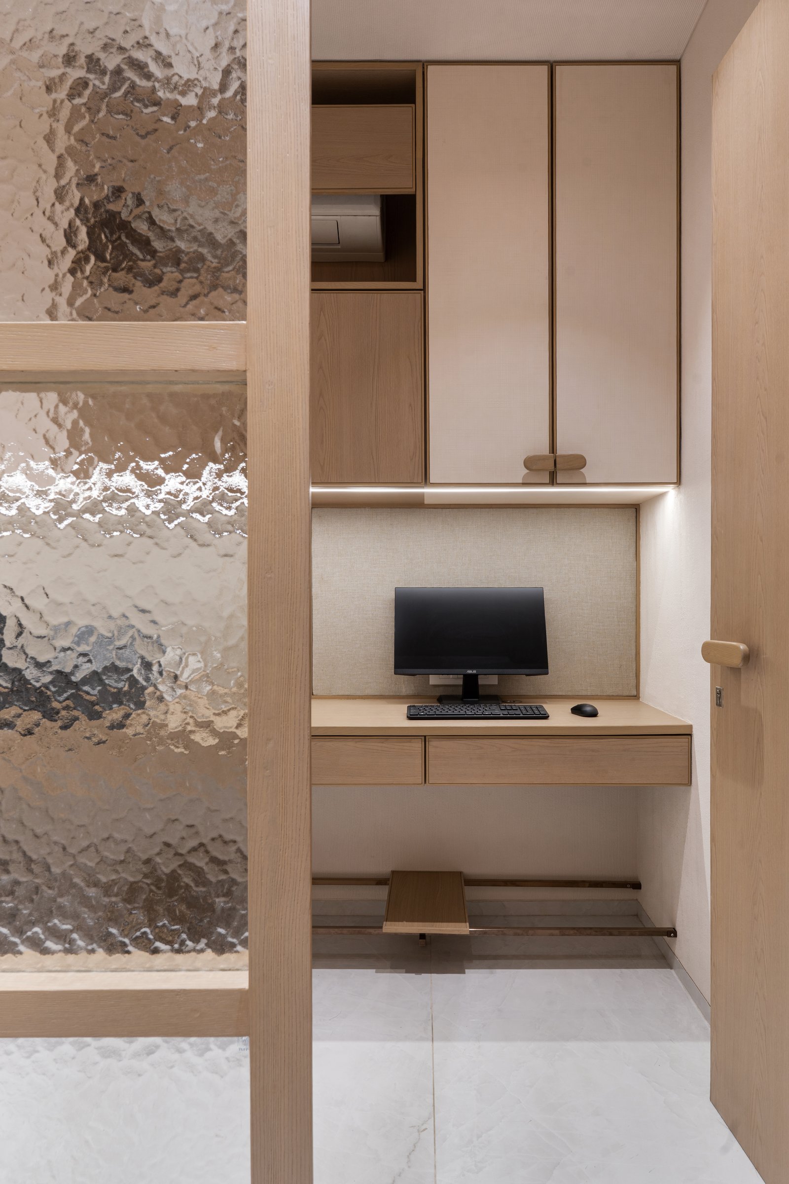 The staff workstation, treated with the same care as the front-of-house: built-in joinery and an upholstered pinboard