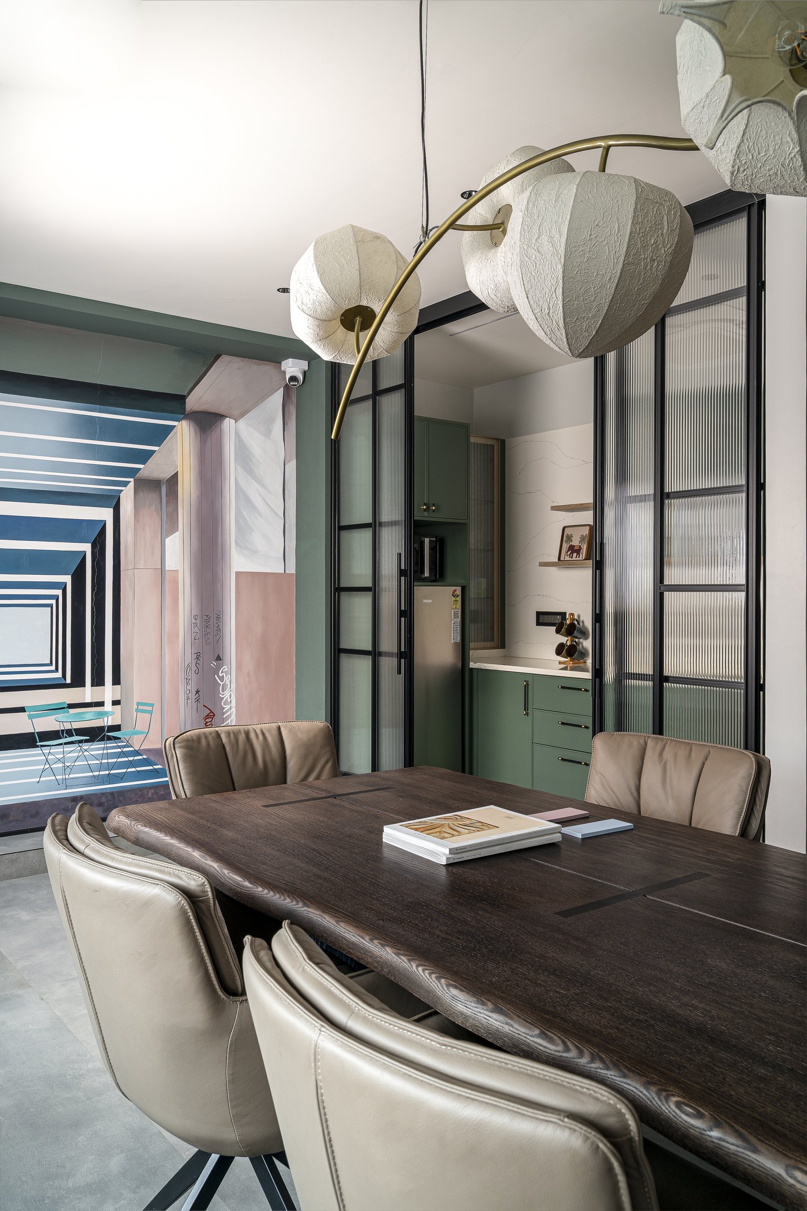 The pantry, screened by fluted glass in black metal framing, reads as a composed still life rather than a service zone