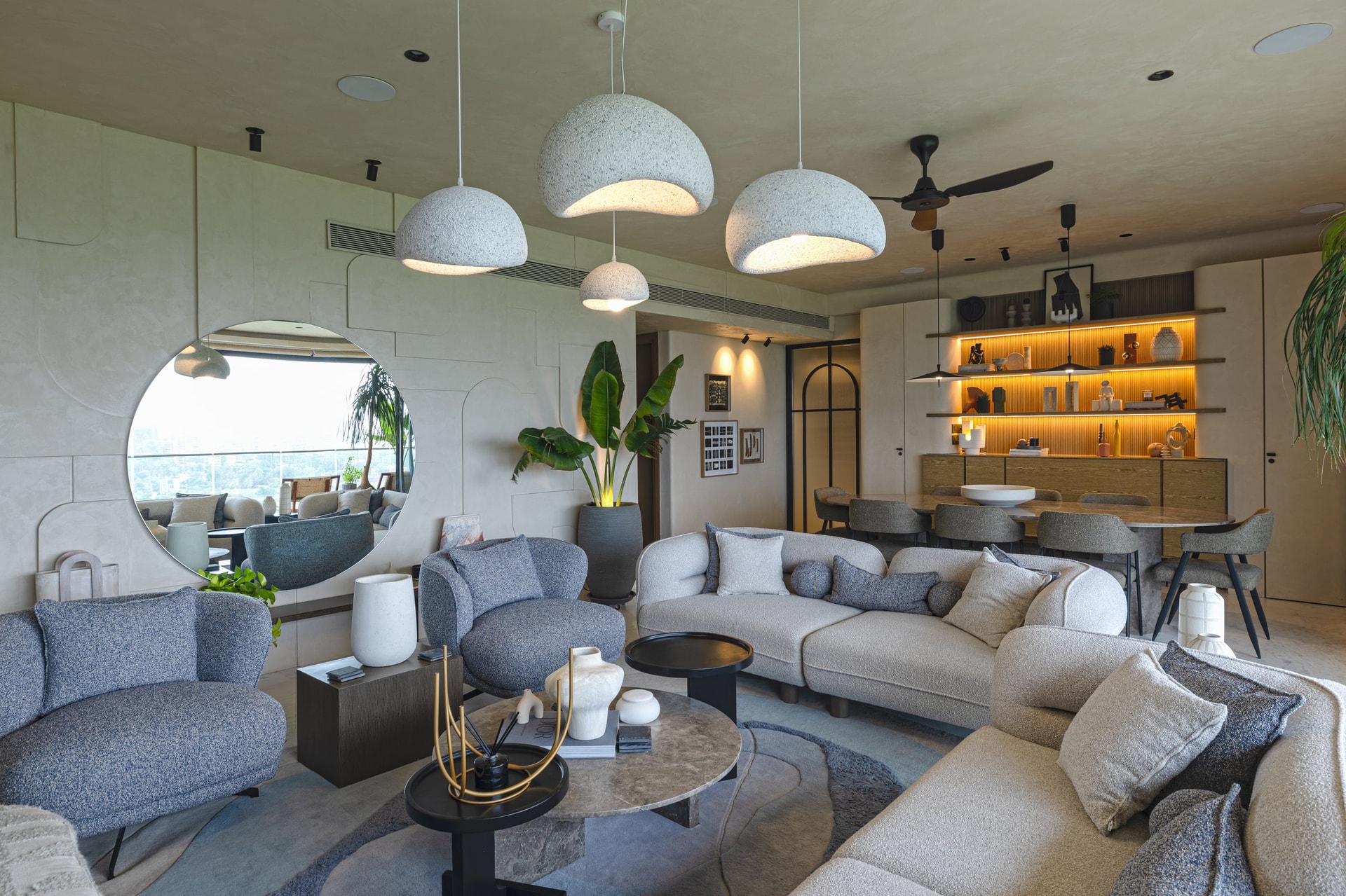 The living volume in soft, sand-toned plaster, the palette engineered to counter the tropical climate with quiet warmth