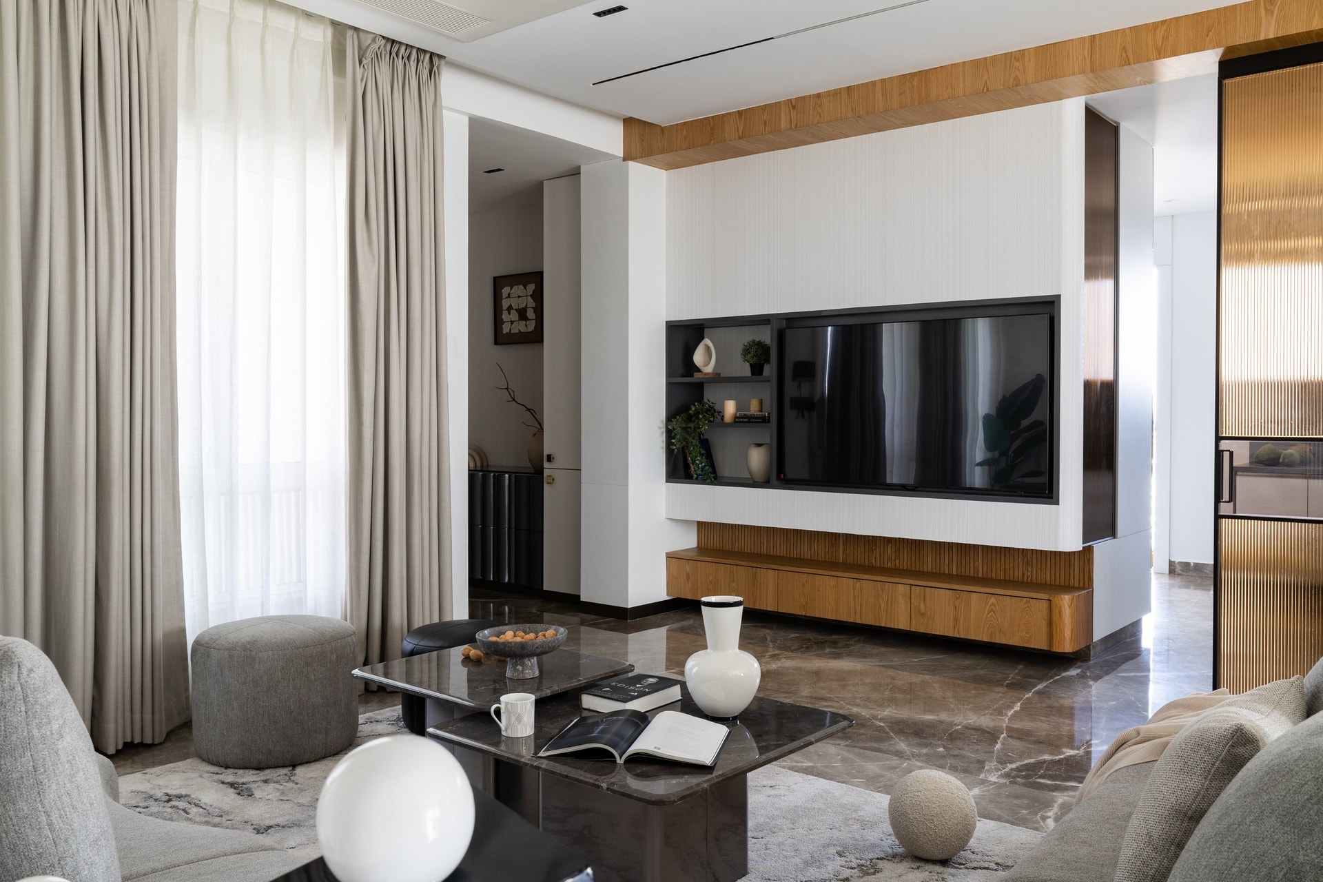 The media wall, reinterpreting the television niche as architecture with a slatted wooden console below