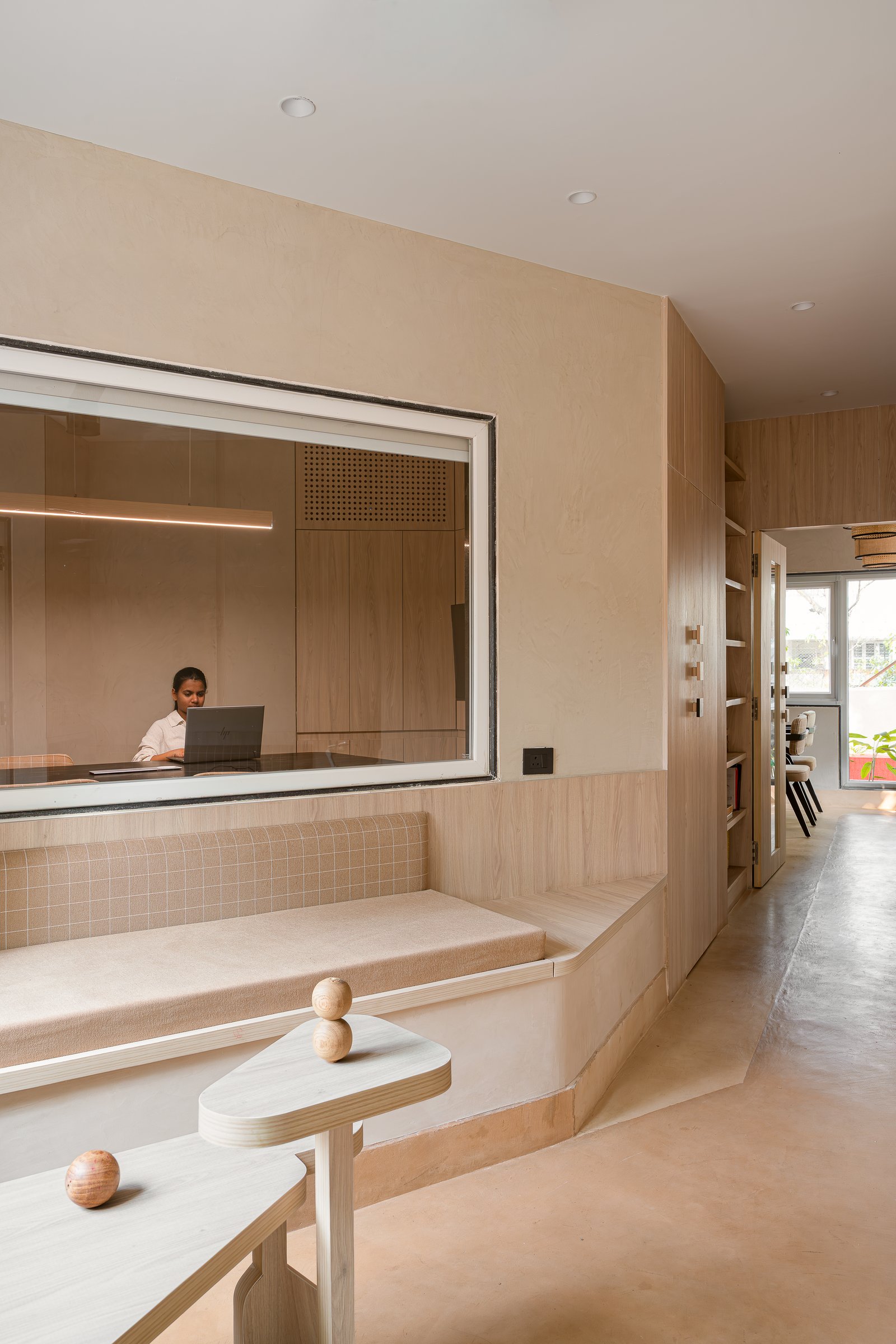 From the waiting bench, the microcrete floor carries the eye through to the rear garden