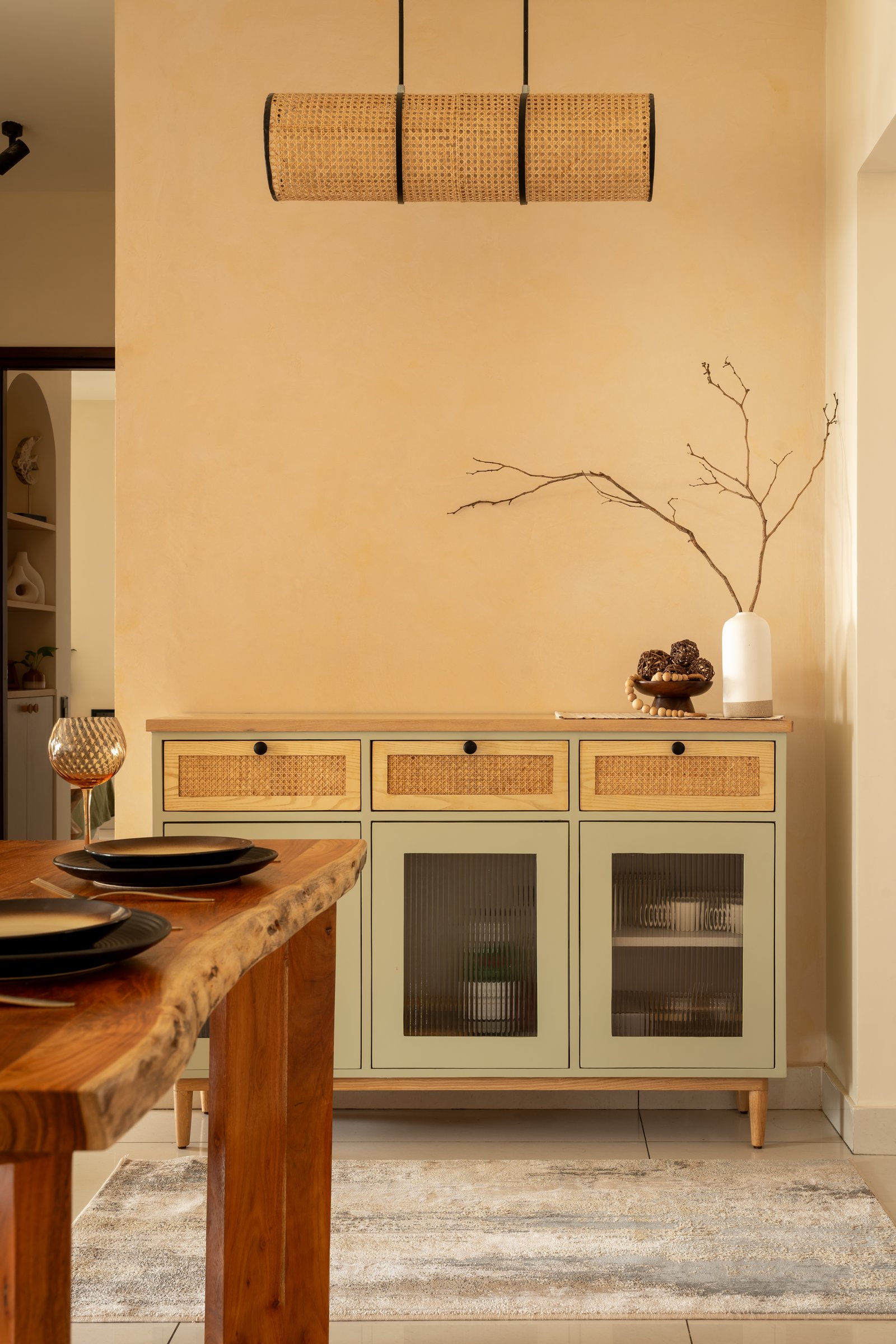 The kitchen, organised around pale wood and a white quartz counter rather than around any decorative gesture