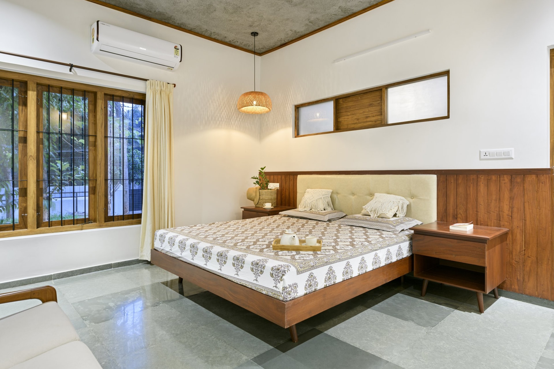 The principal bedroom, an upholstered headboard set into a panelled wooden back wall