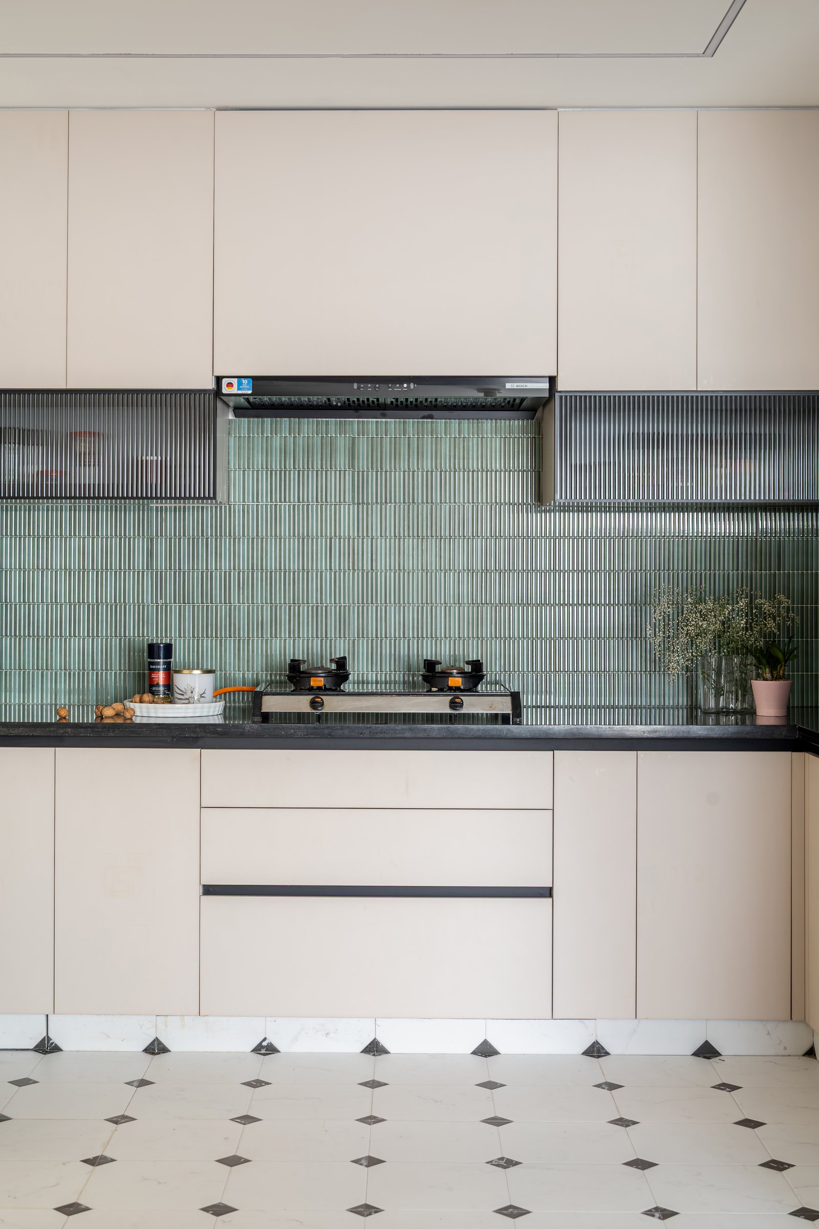The kitchen's checkered marble floor introduces an unexpected European reference into a disciplined Indian apartment