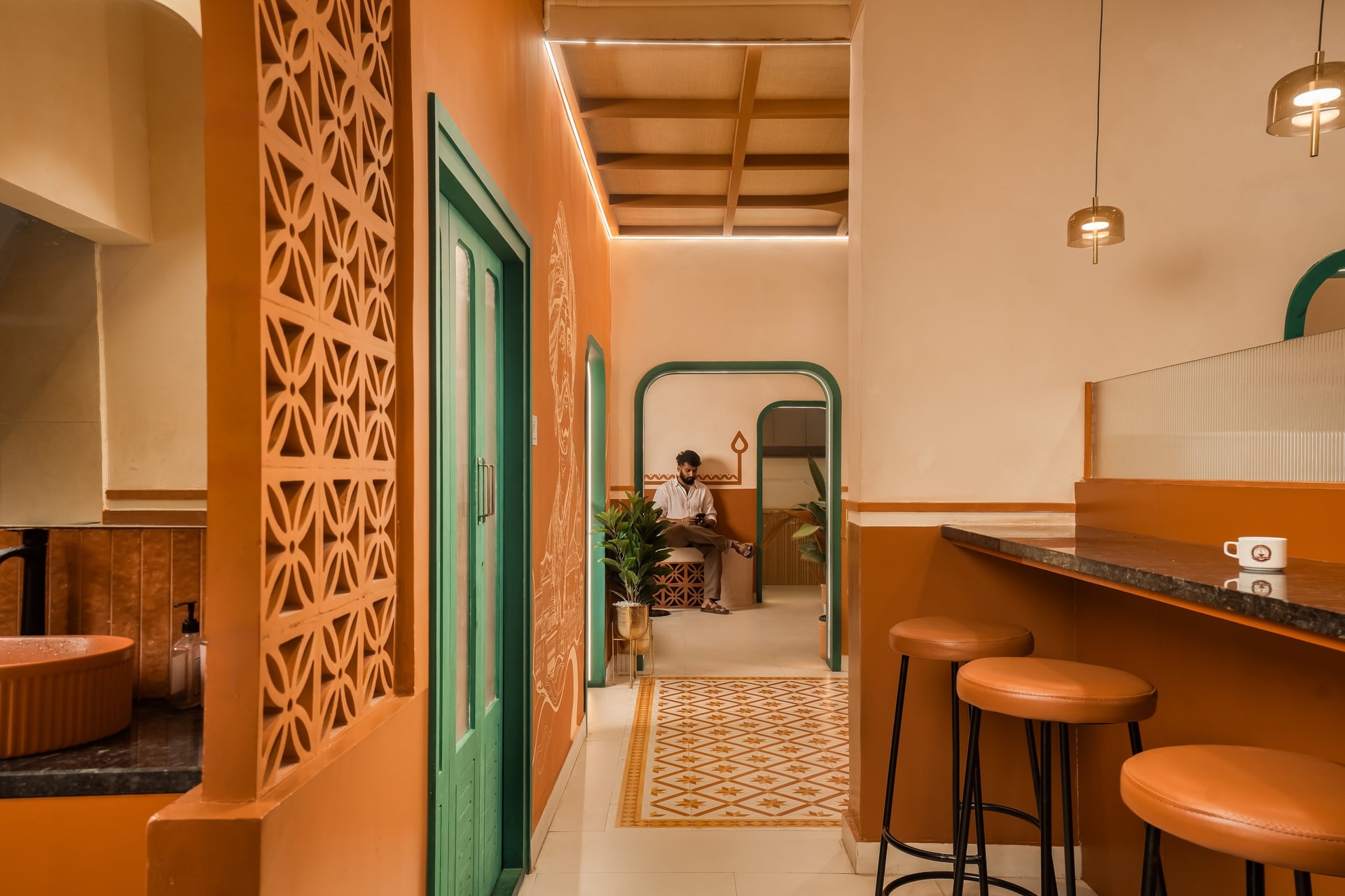 A sightline through arches, jali and mural along the circulation spine between vendors