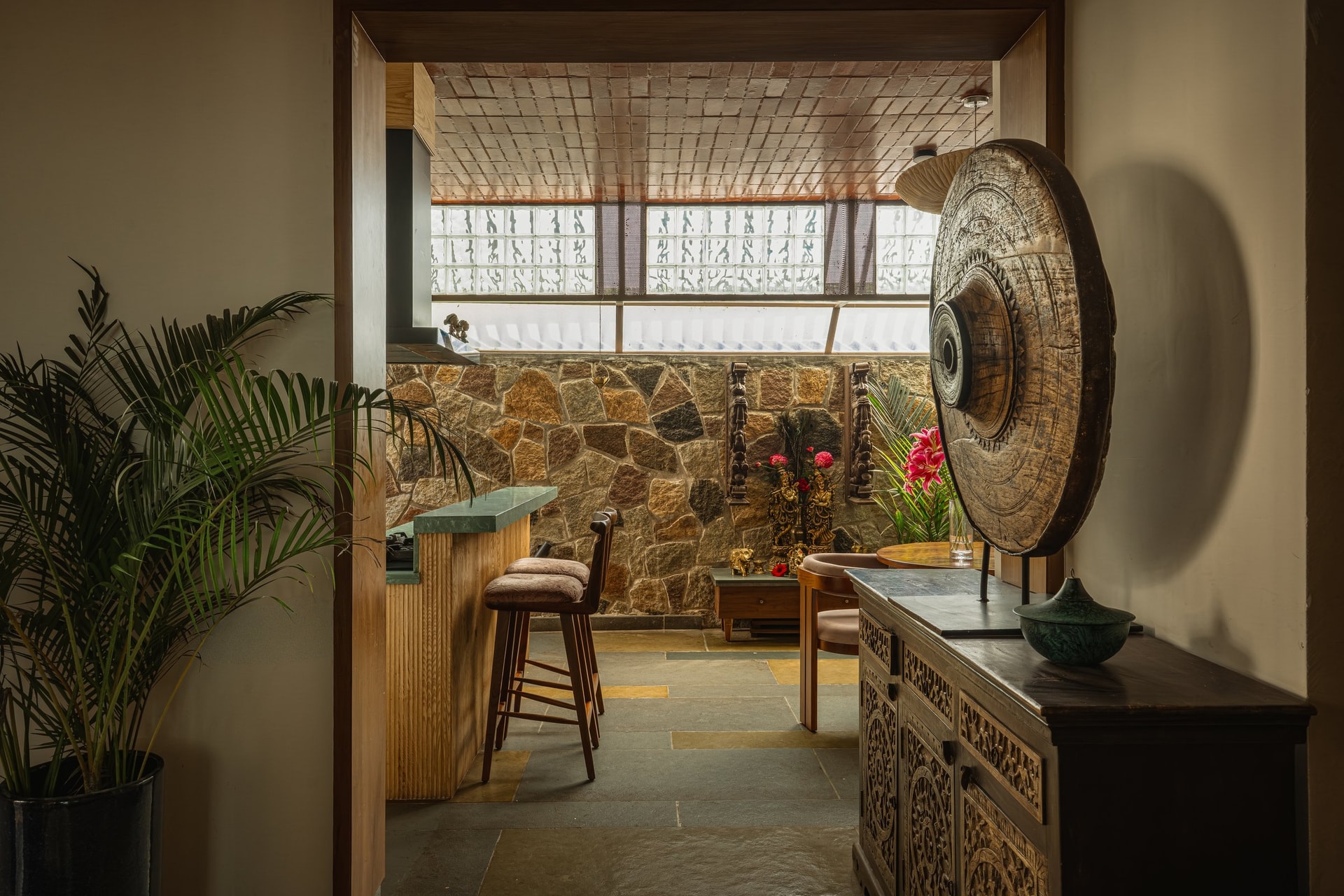The dining volume read from its threshold, the carved sideboard marking the shift from entry to lighter interior