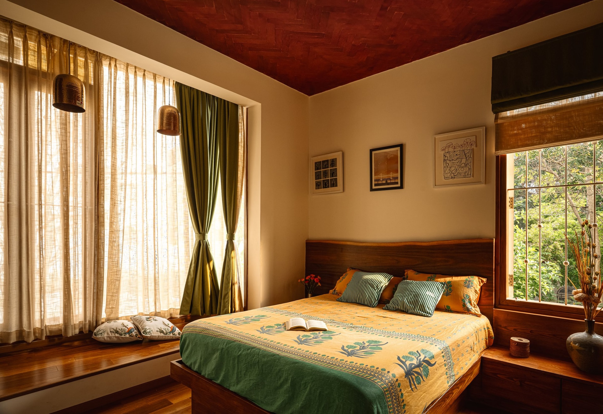 The same bedroom seen wider, where a terracotta-stained herringbone ceiling carries the room's atmosphere