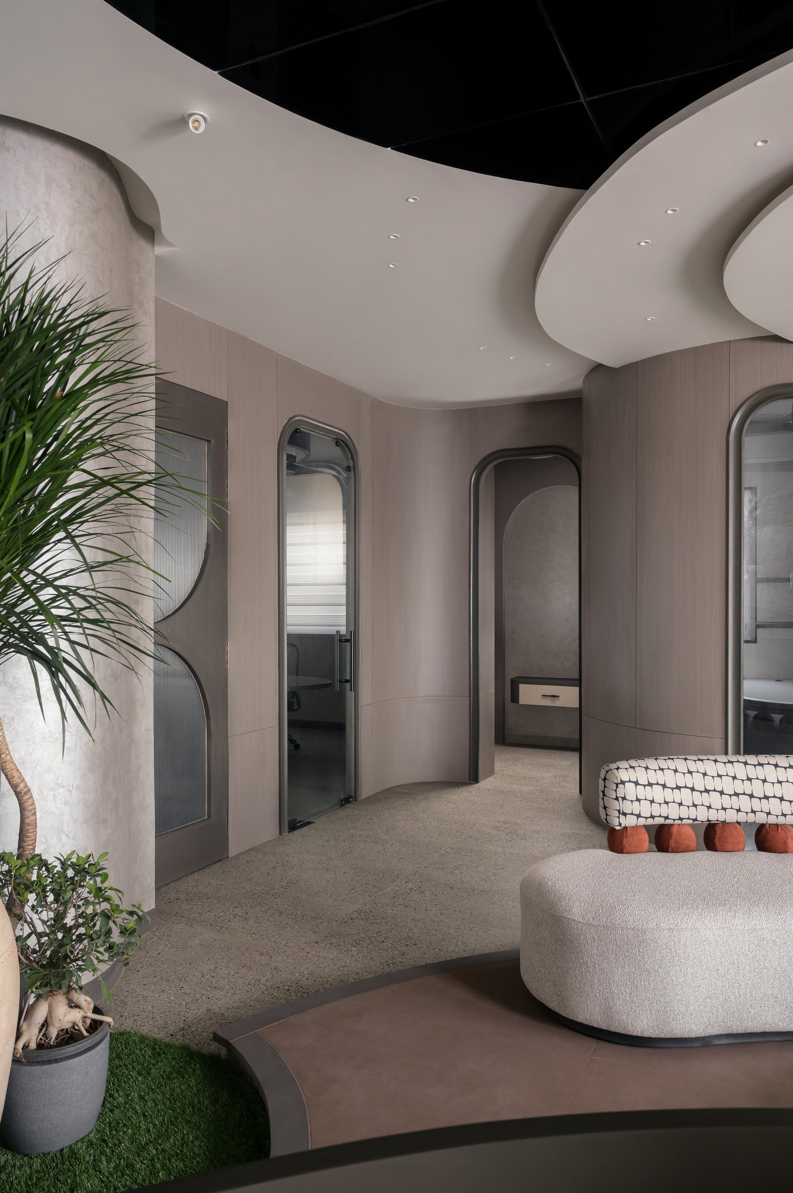 The threshold to the cabins, where wood-panelled walls and arched openings continue the curved vocabulary