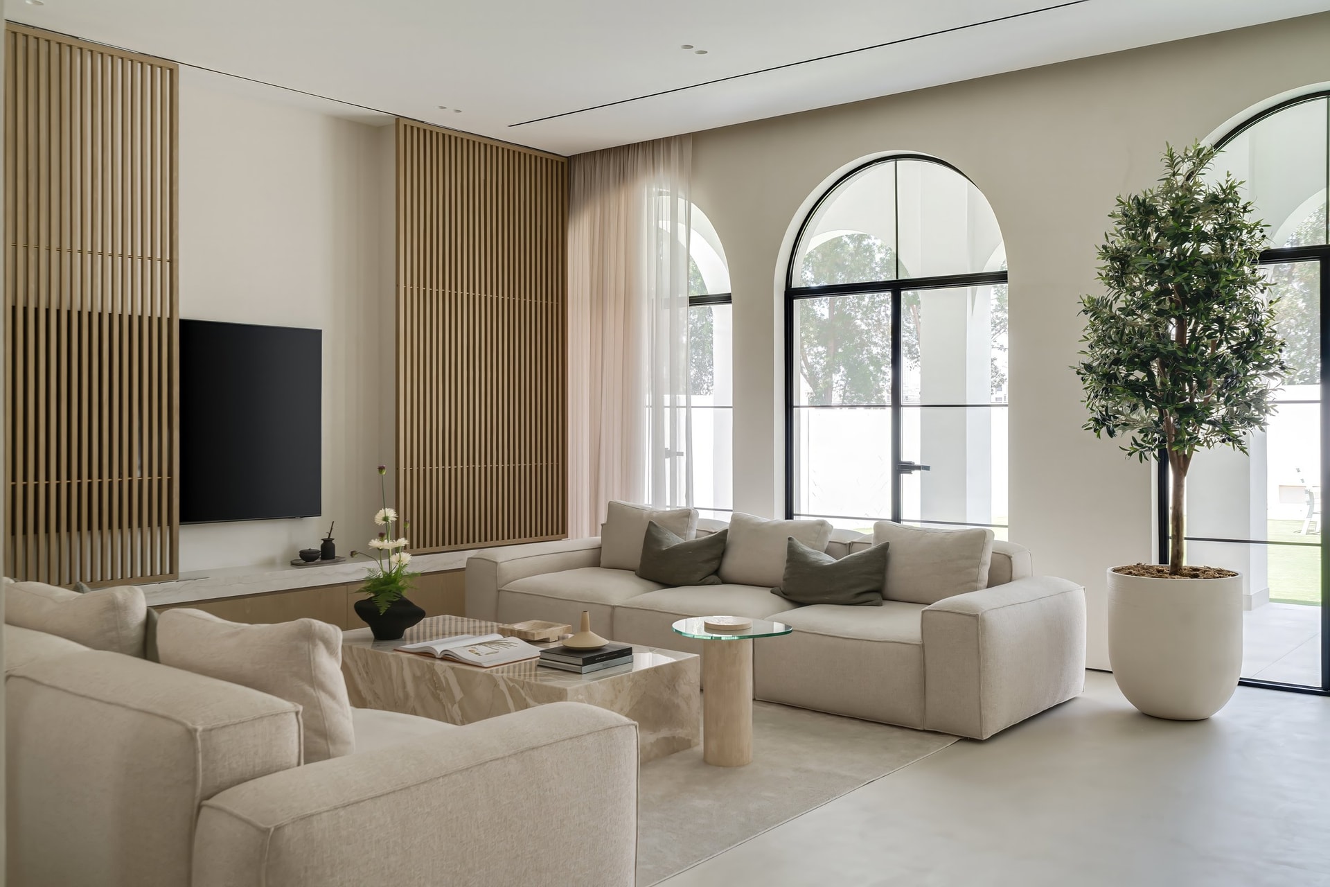 Crittall doors in matte black steel frame the garden as if through a series of paintings