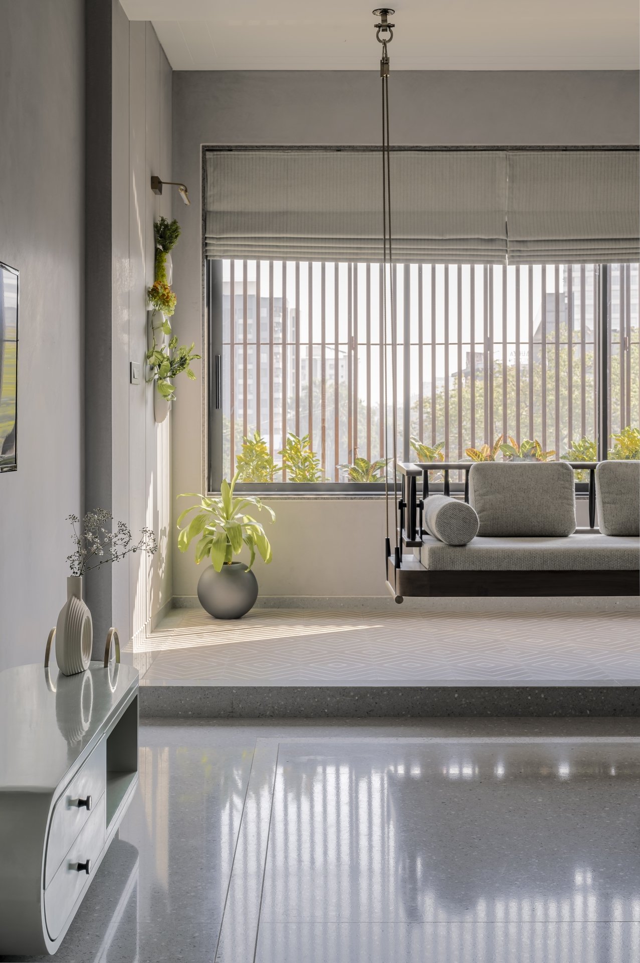 The master bedroom, where a cushioned swing faces a slatted timber-screened window