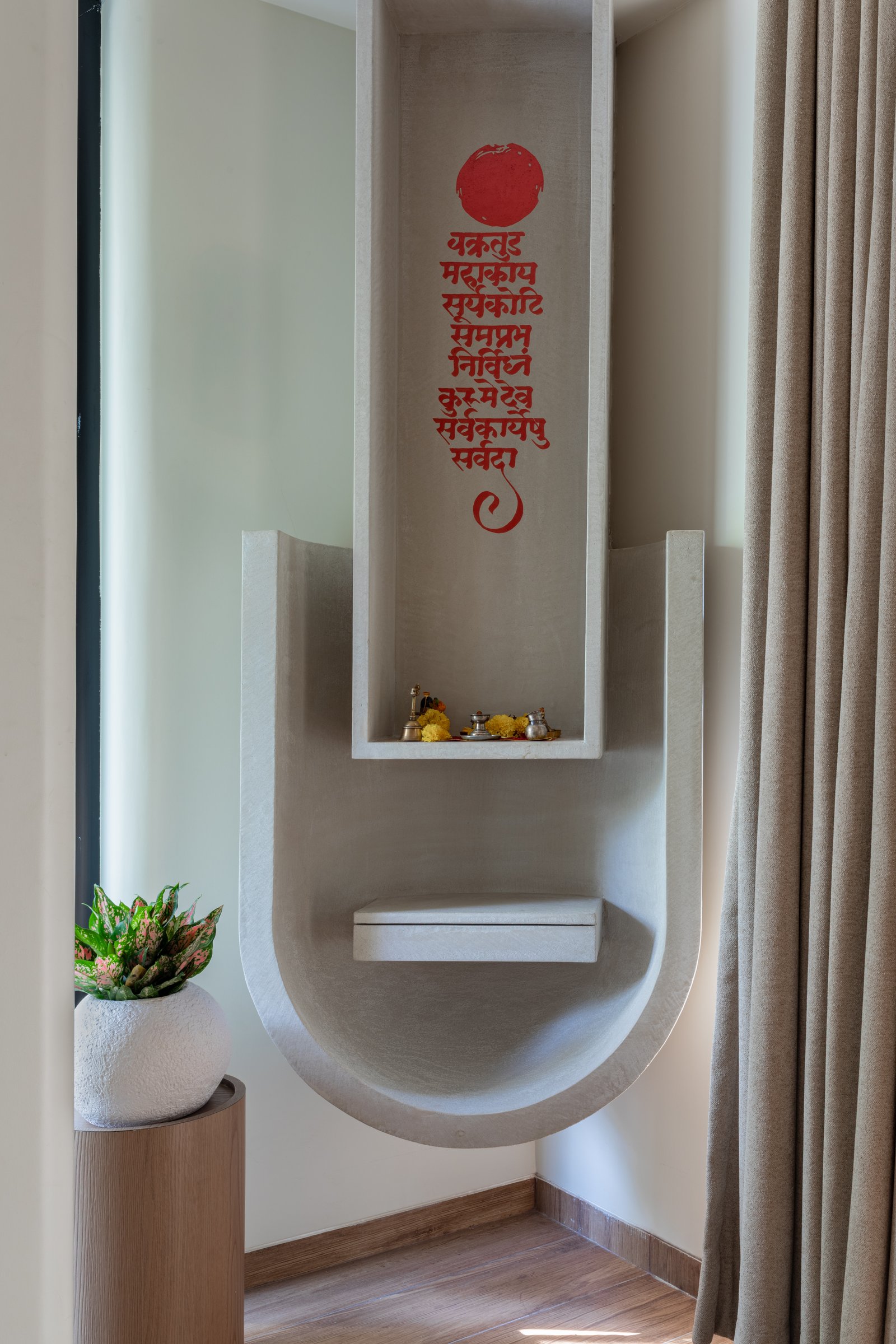 The pooja niche, where the home's curved vocabulary translates into ritual