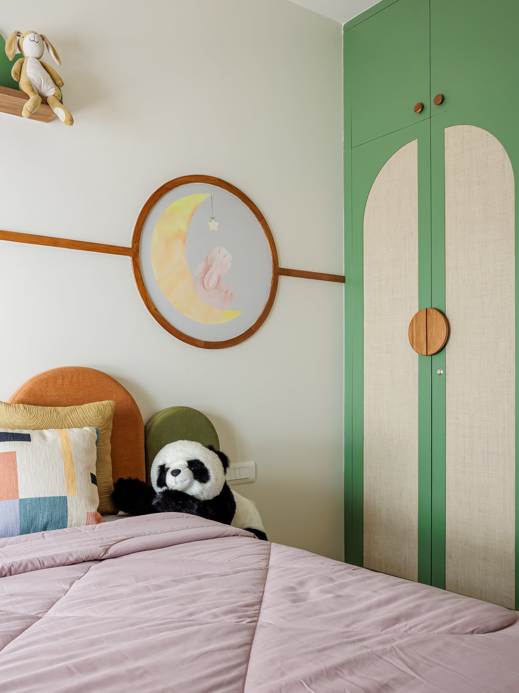 The wardrobe wall, where parrot-green shutters carry tall arched inserts of woven grass cloth
