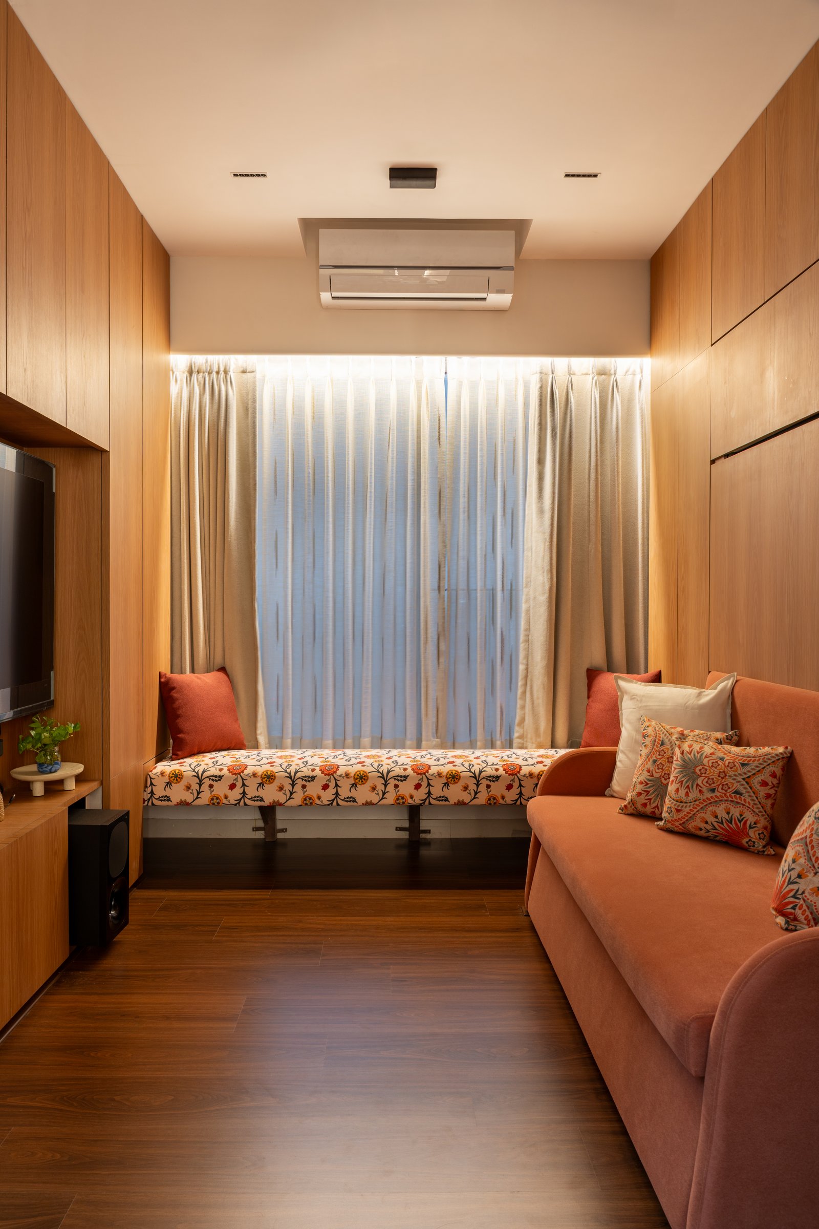 The same room by day, functioning as an extension of the living space with a window seat and folded sofa
