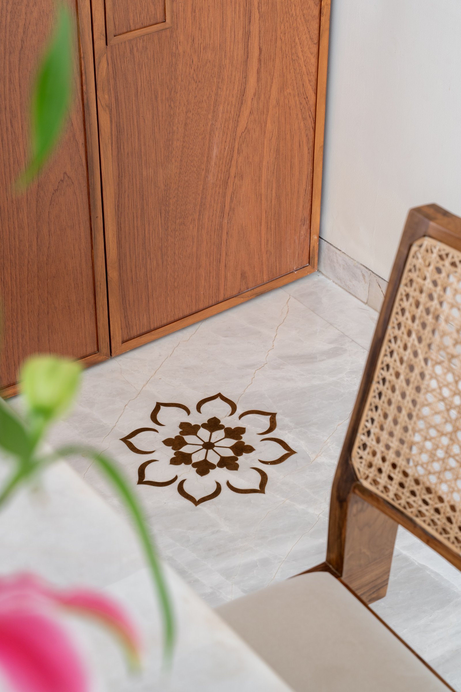 An inlaid floor motif in dark stone, marking a threshold between rooms