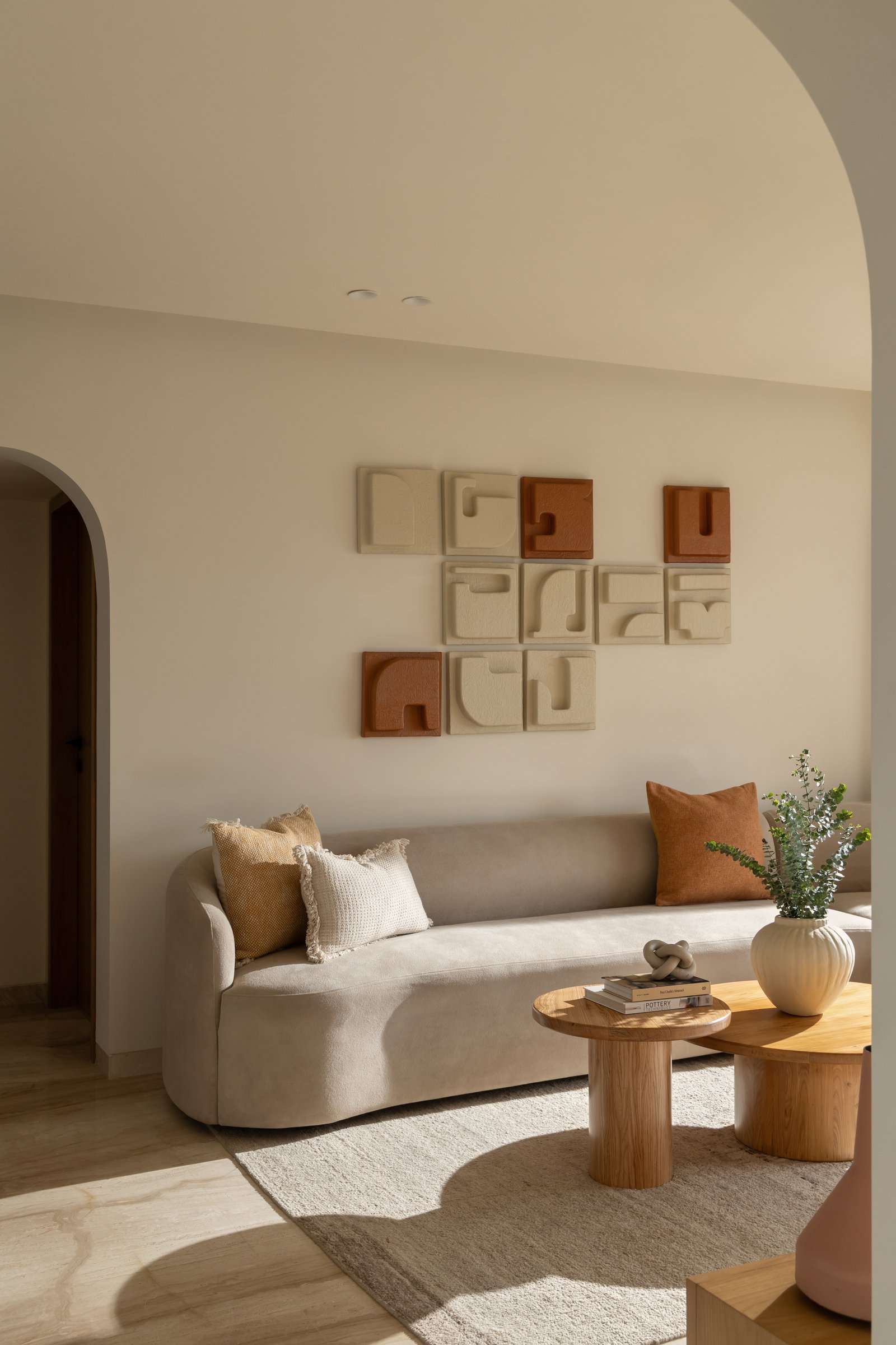A commissioned grid of nine ceramic reliefs in ivory and rust, composed to be rearranged over time