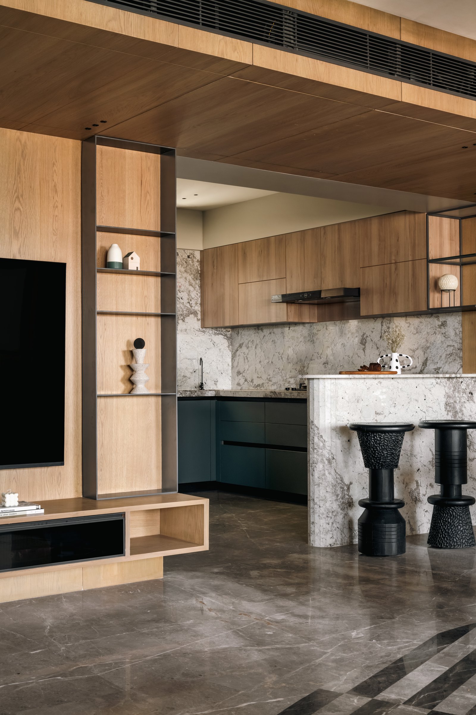 The dining zone from the informal seating side, revealing the veneered wall of concealed storage