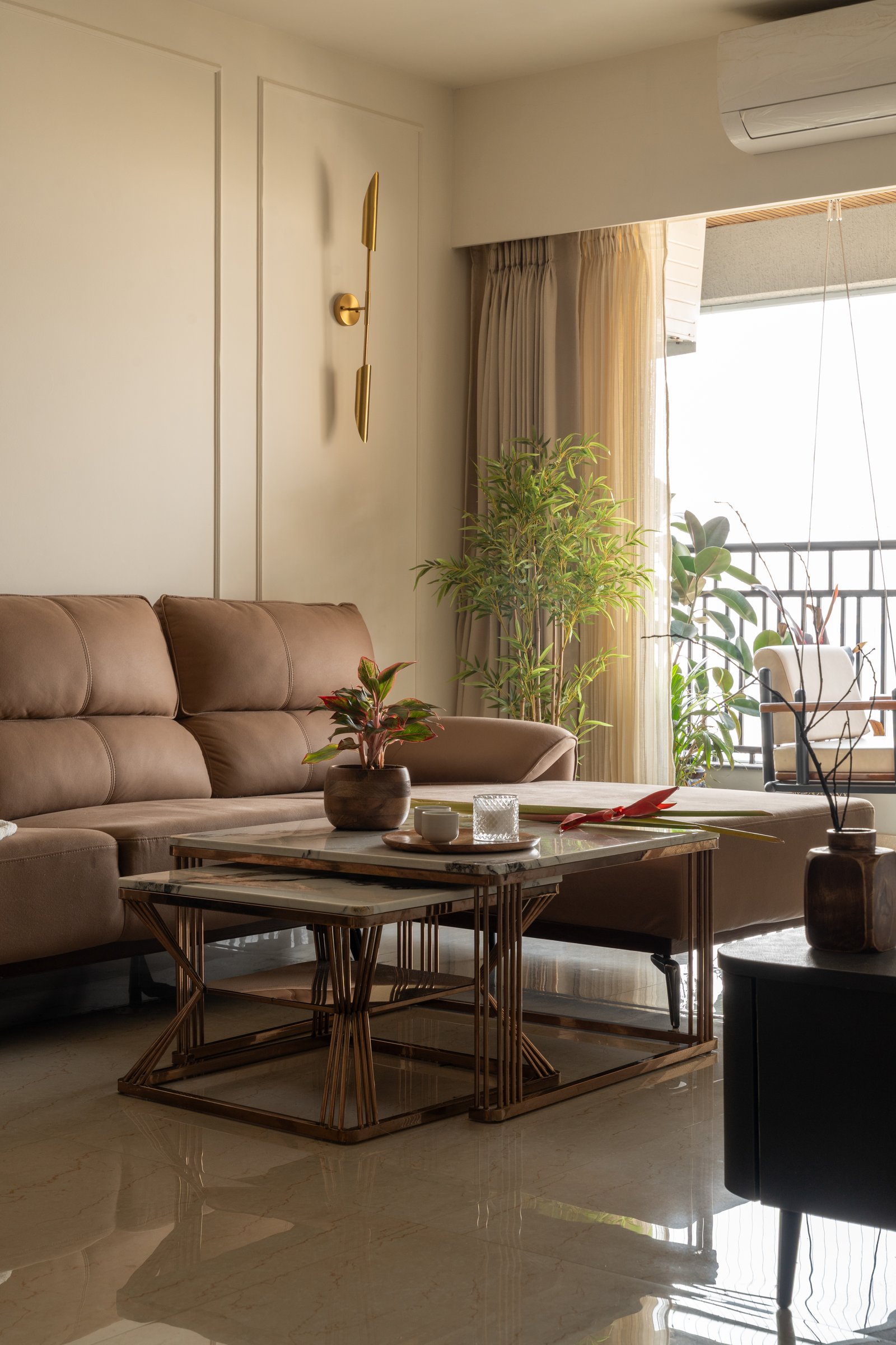 A closer view of the seating: leather, marble-topped nesting tables and greenery drawn in from the balcony
