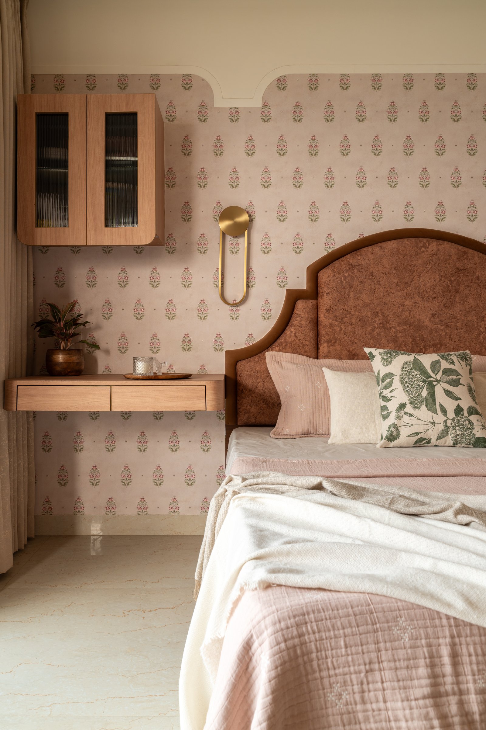 A quieter view of the master, the wall-hung cabinet and floating desk in warm wood recessive against the pattern