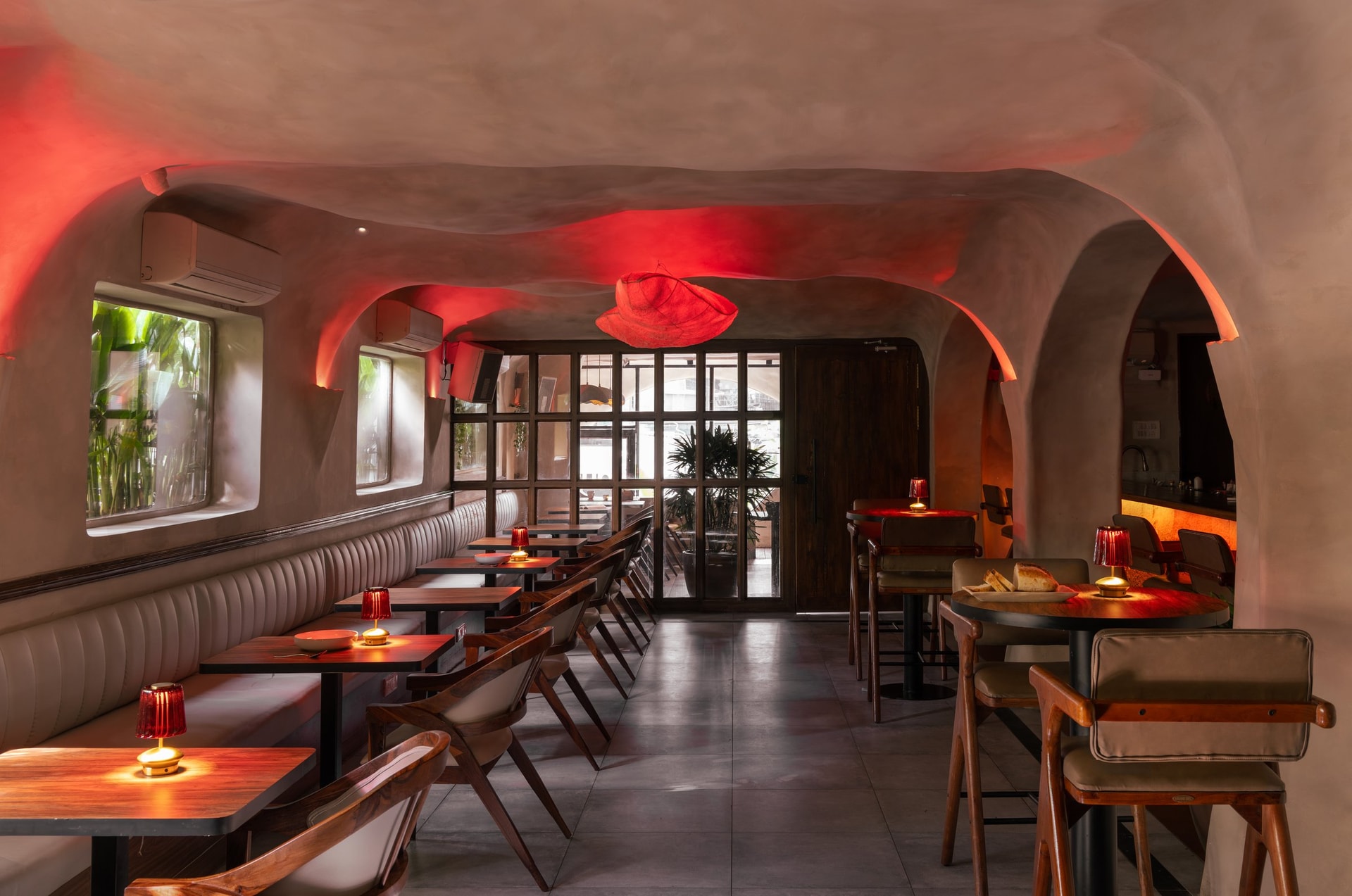 The same view by night, the ceiling and pendant washed in saturated red