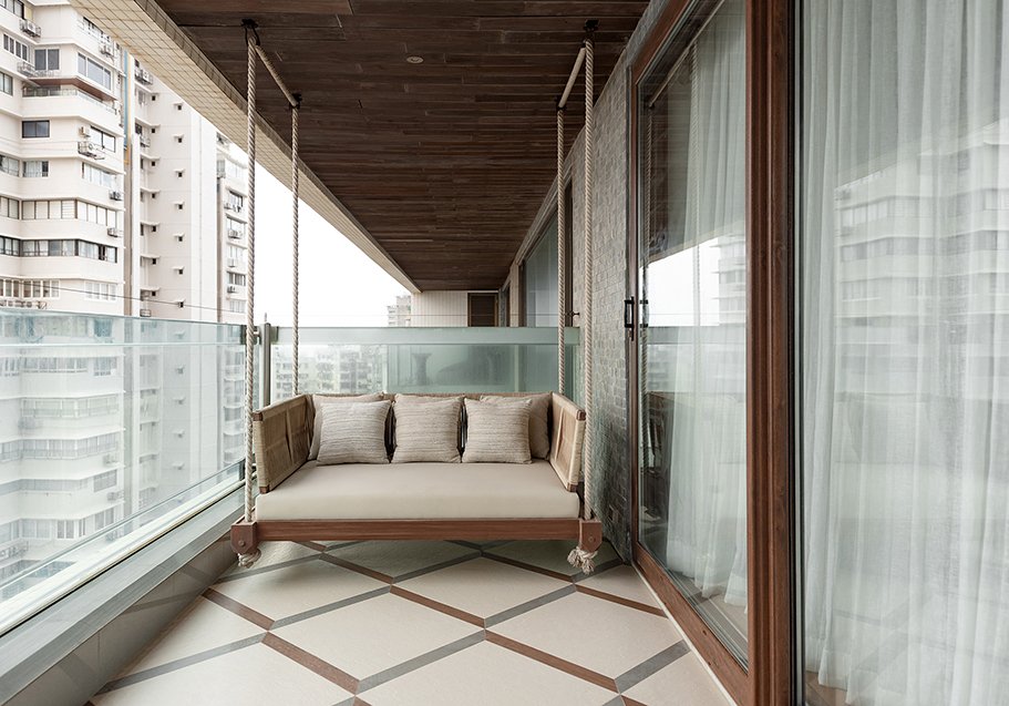 The first balcony, where a suspended daybed overlooks the city at eye level