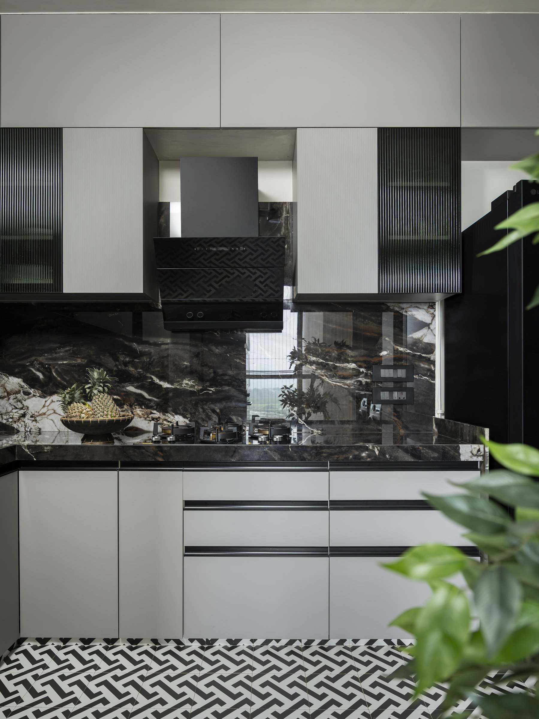 The dramatically veined dark stone backsplash paired with pale grey ASL laminate cabinetry