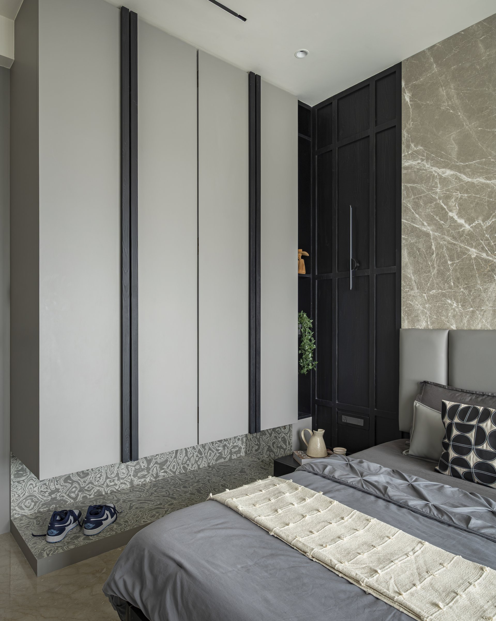 The open shoe-display niche, where a boldly patterned stone lining turns a utilitarian need into a feature