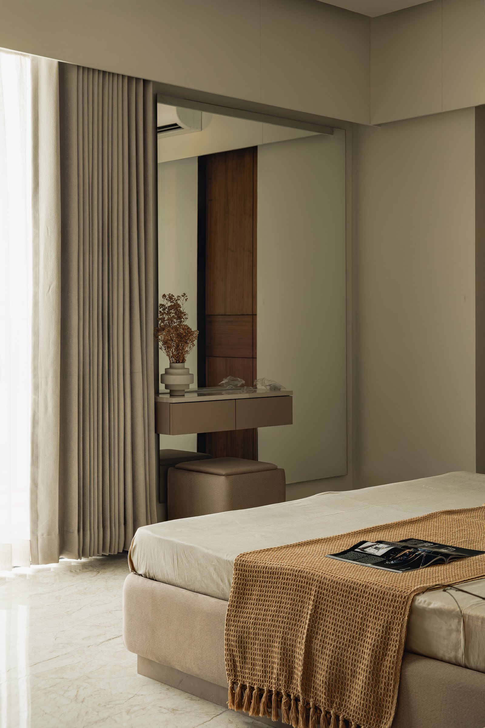 The vanity opposite the bed, with a full-height mirror reflecting the wooden-panelled wall across the room