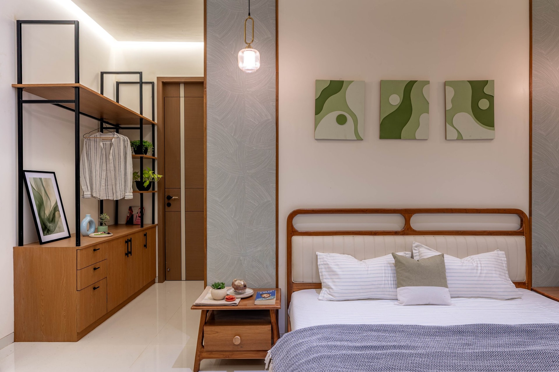 The green-accented bedroom, where the same teak-and-white vocabulary gains a different chromatic identity