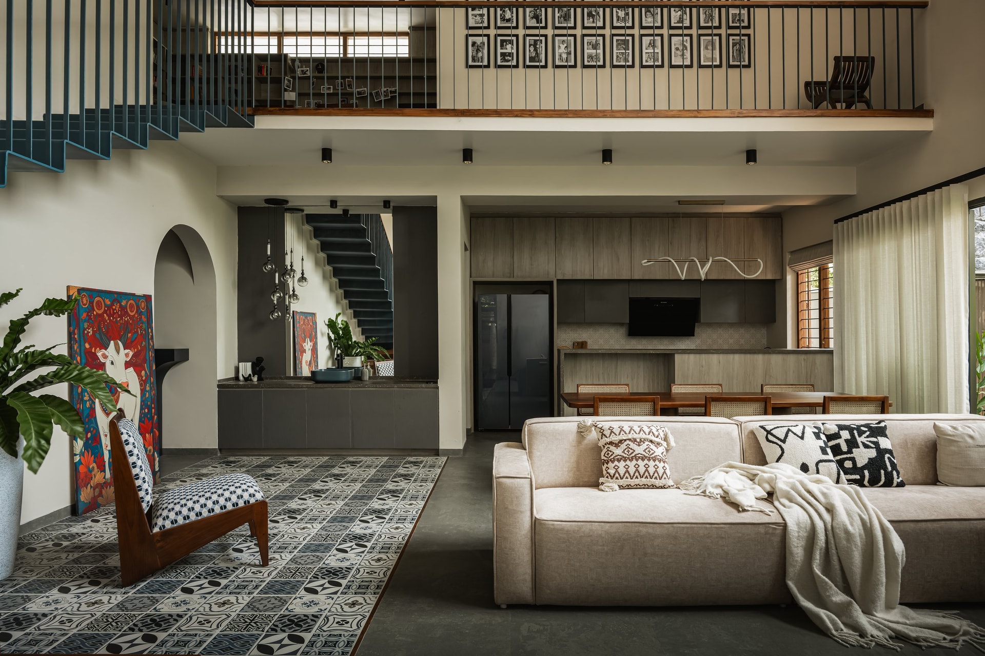 The social heart of the home, where living, dining and kitchen unfold beneath the mezzanine as a single continuous gesture