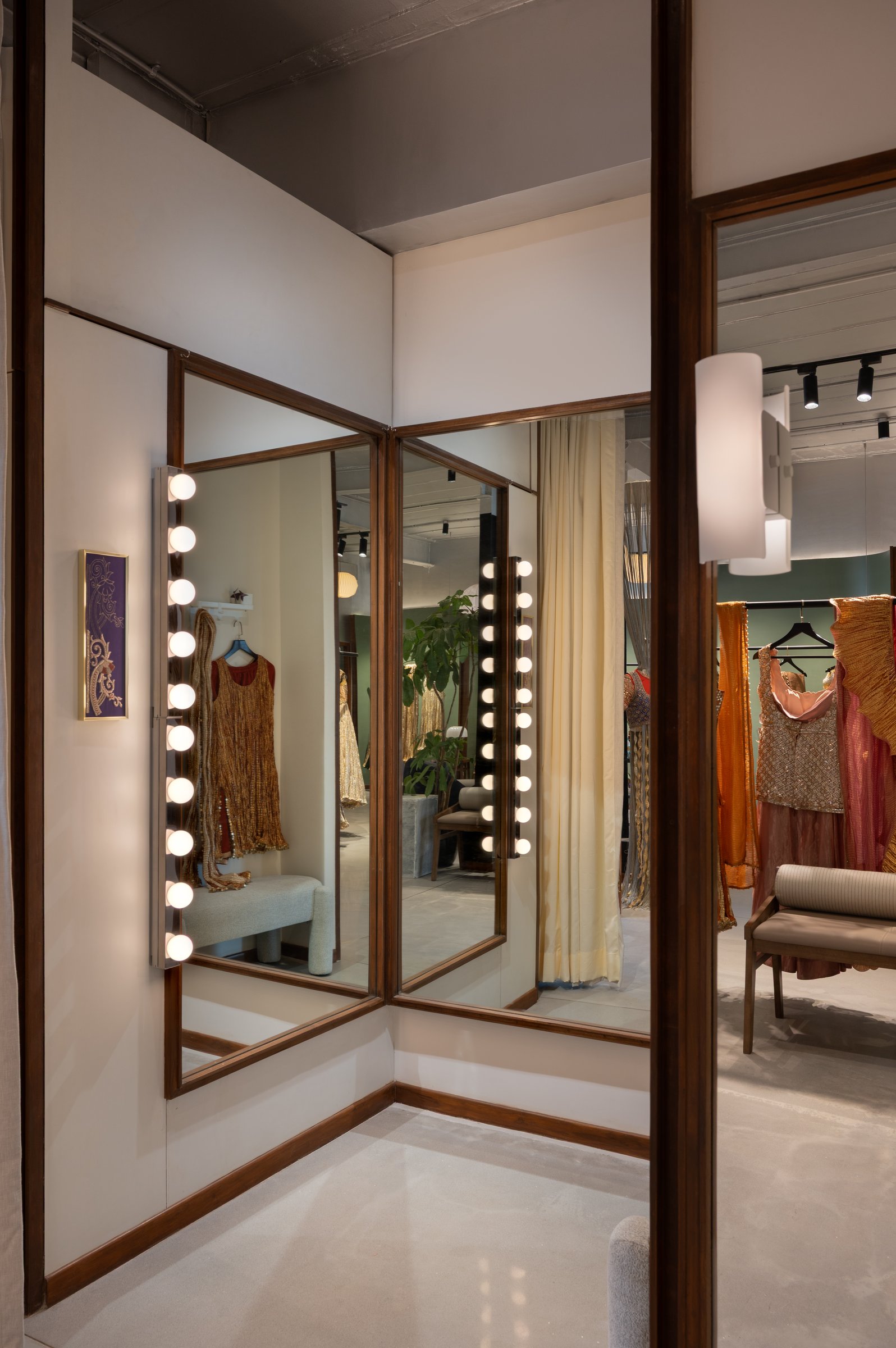 A closer view of the mirror corner, where the joinery and reflections continue the project's restraint