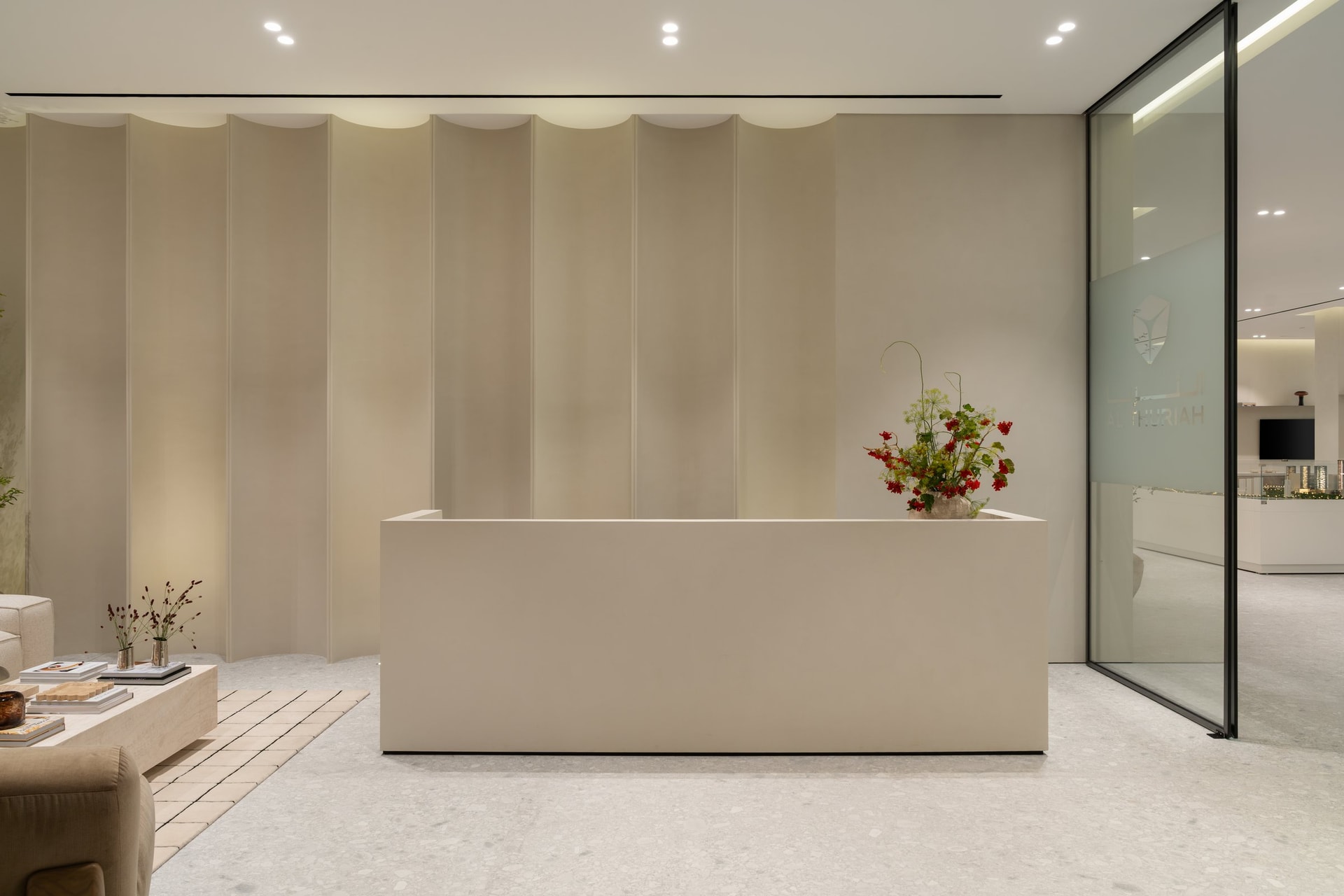 The eighth-floor reception, where the ground floor's panelling and stone reappear to confirm a consistent brand identity