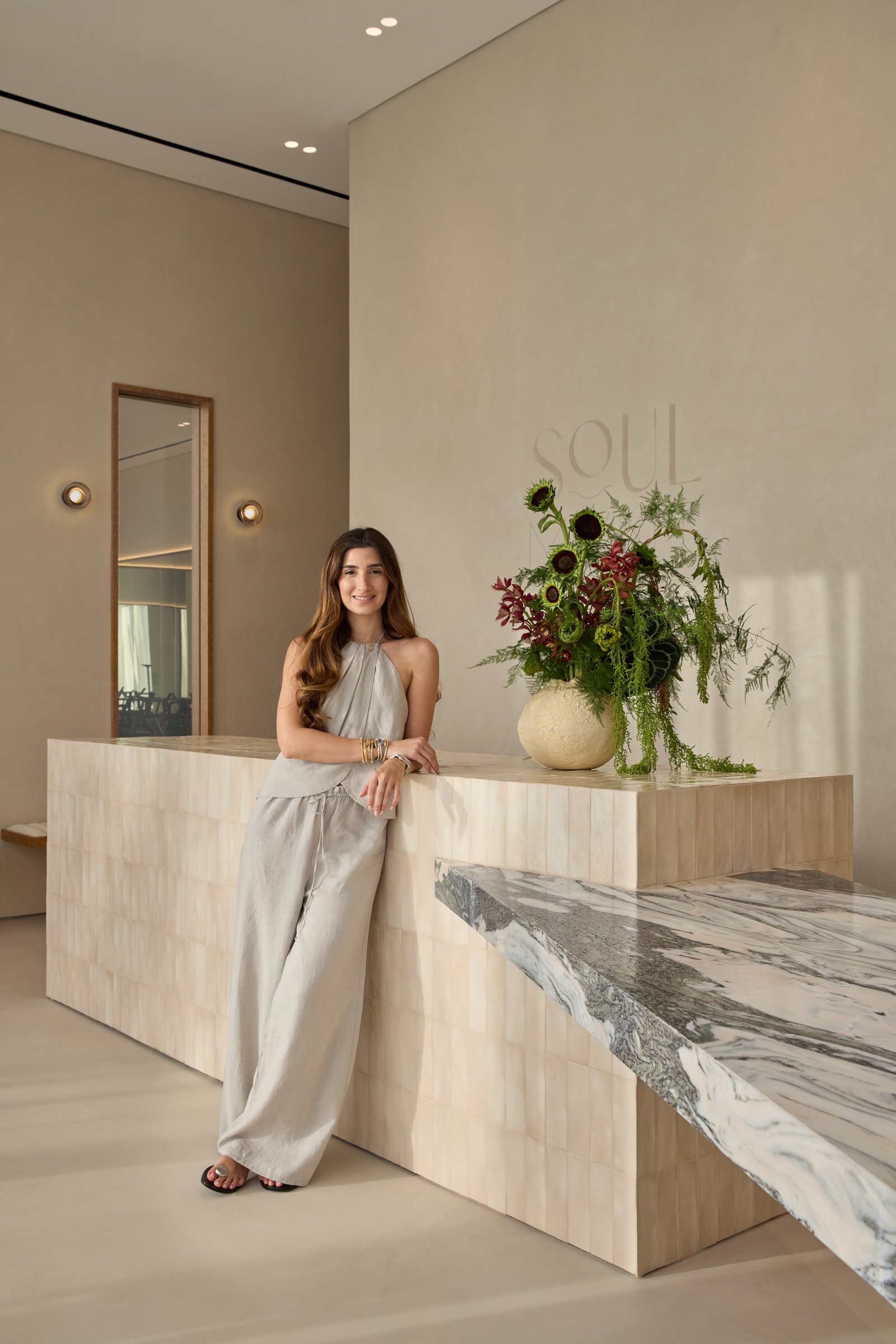 The reception desk in handmade ivory tiles, with an Avalanche marble shelf cantilevered to one side