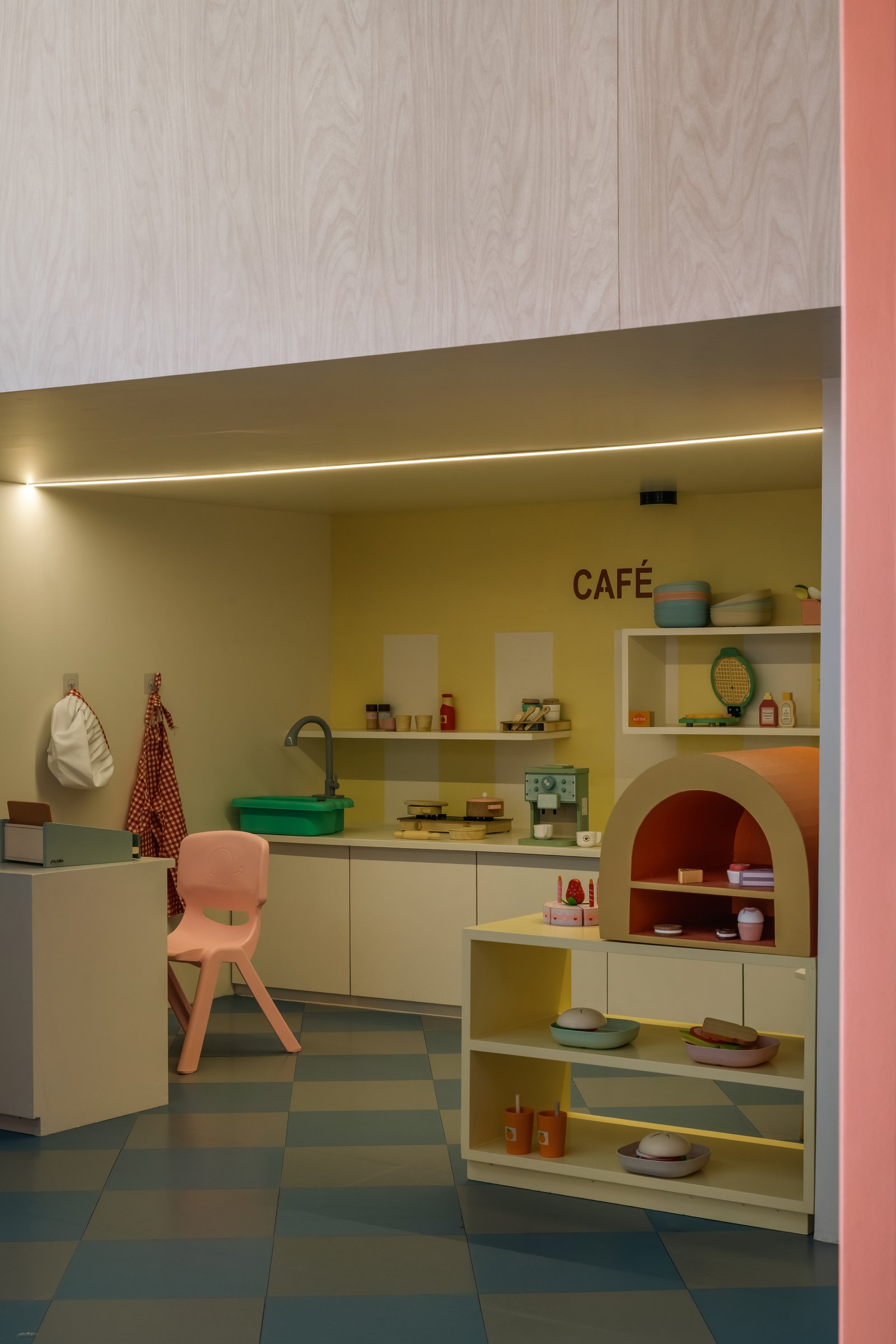 The pretend-play Café, where a coral-arched pizza oven mirrors the architectural arches outside at toy scale