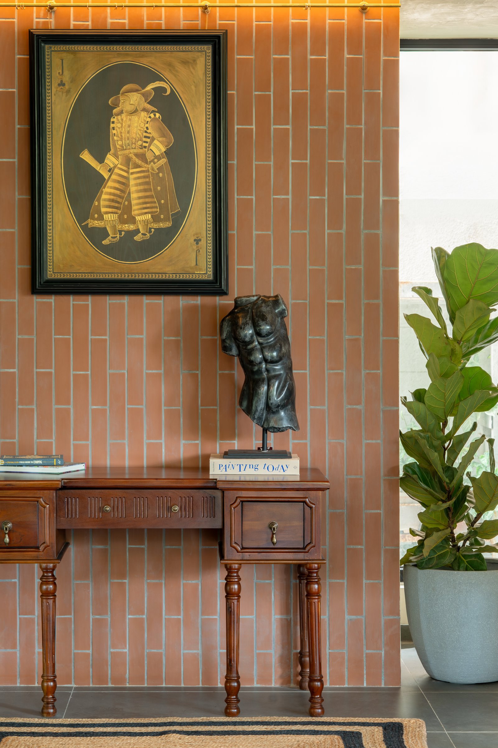 Vertical terracotta tiles bring the building's exterior brick logic indoors as a textured display wall