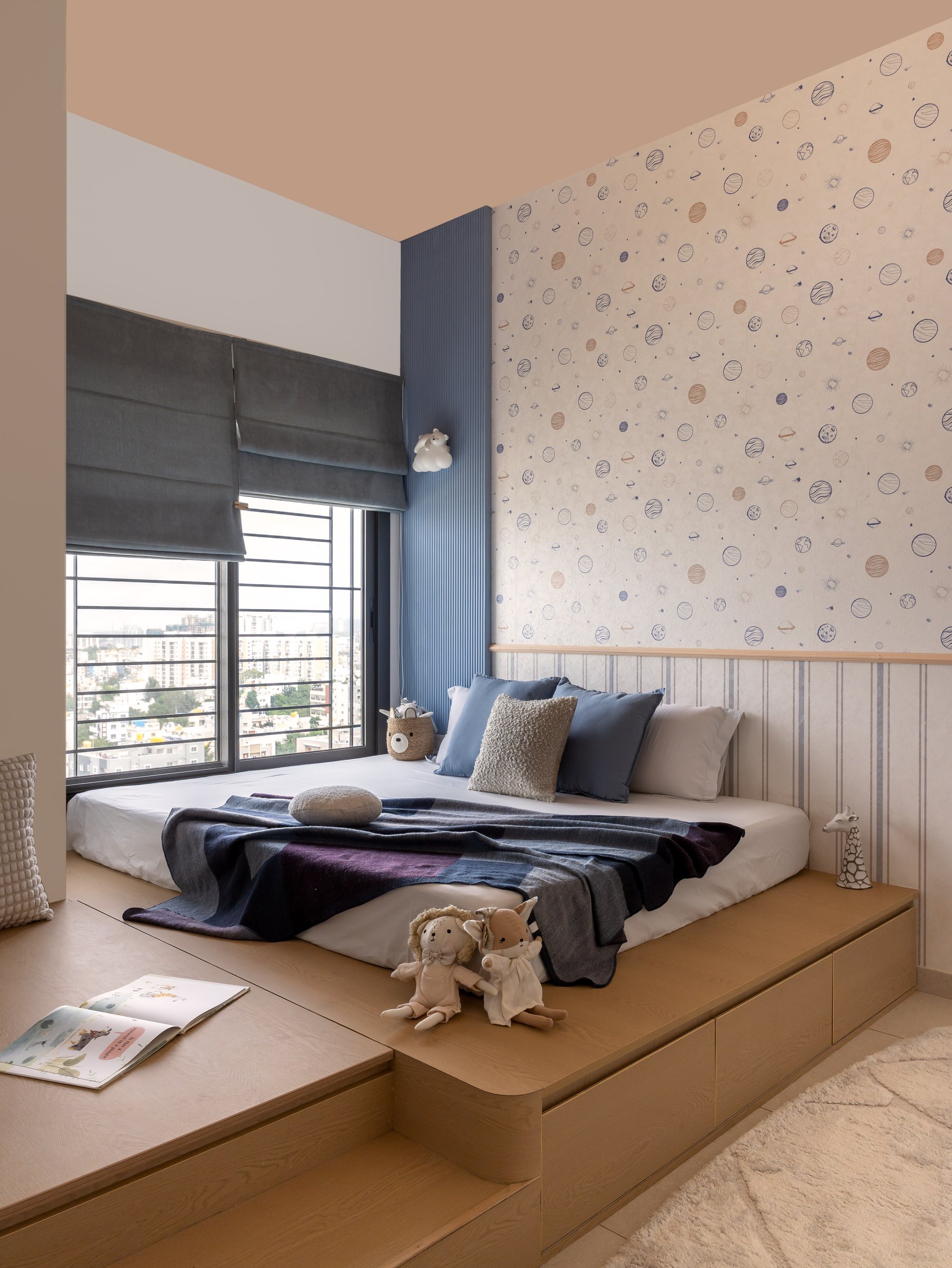 The children's bedroom, where a peach ceiling and a celestial wall make room for wonder without noise