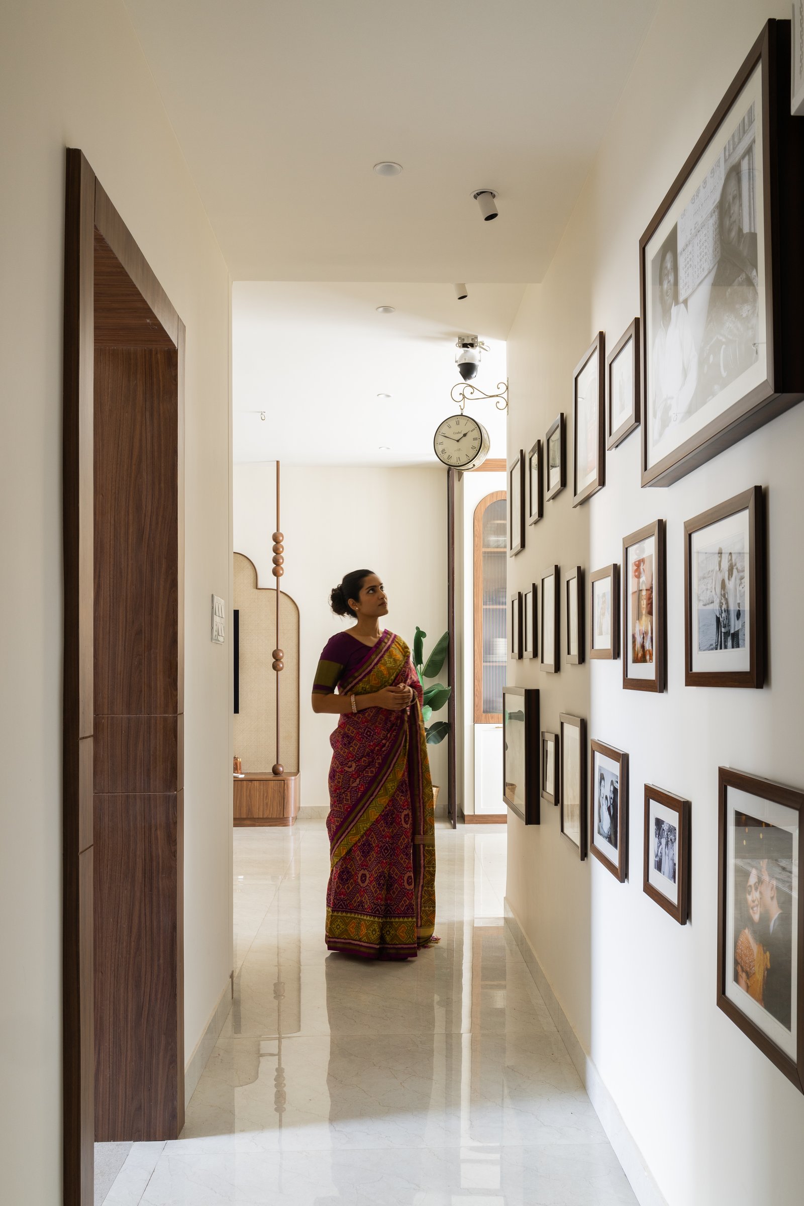The passage, treated as a continuation of the living-room gallery rather than as circulation