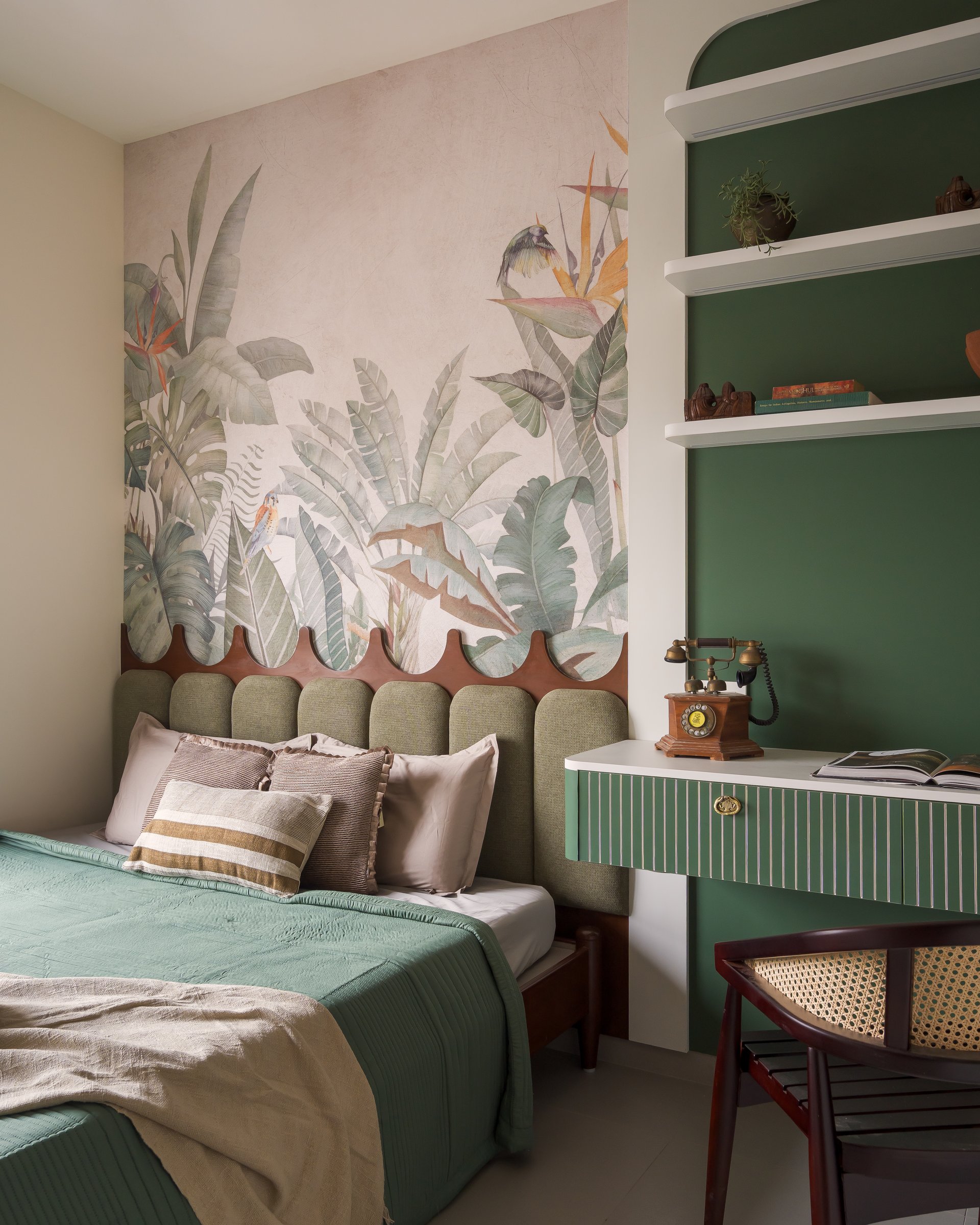 The children's bedroom, where a tropical mural above a scalloped wooden trim frames the headboard wall