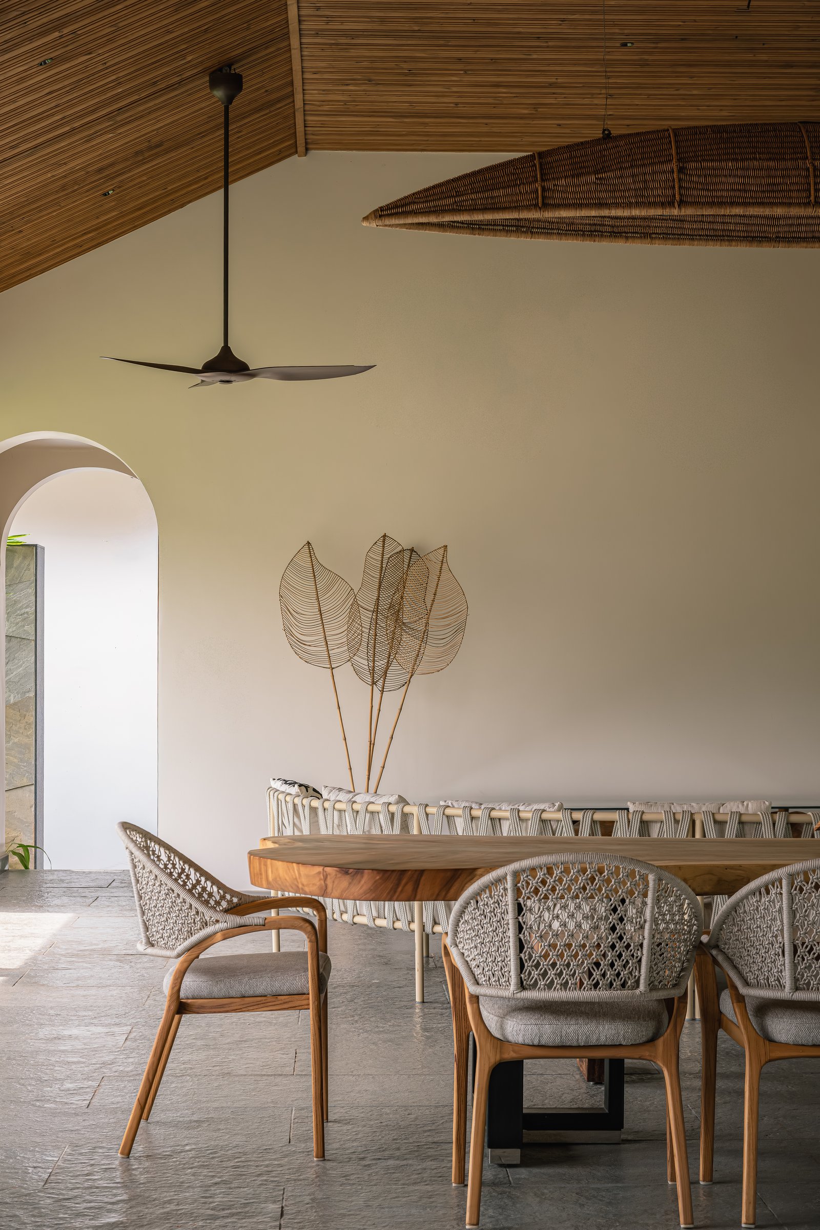A quieter corner of the pavilion, with a wire-and-reed leaf sculpture as its single ornament
