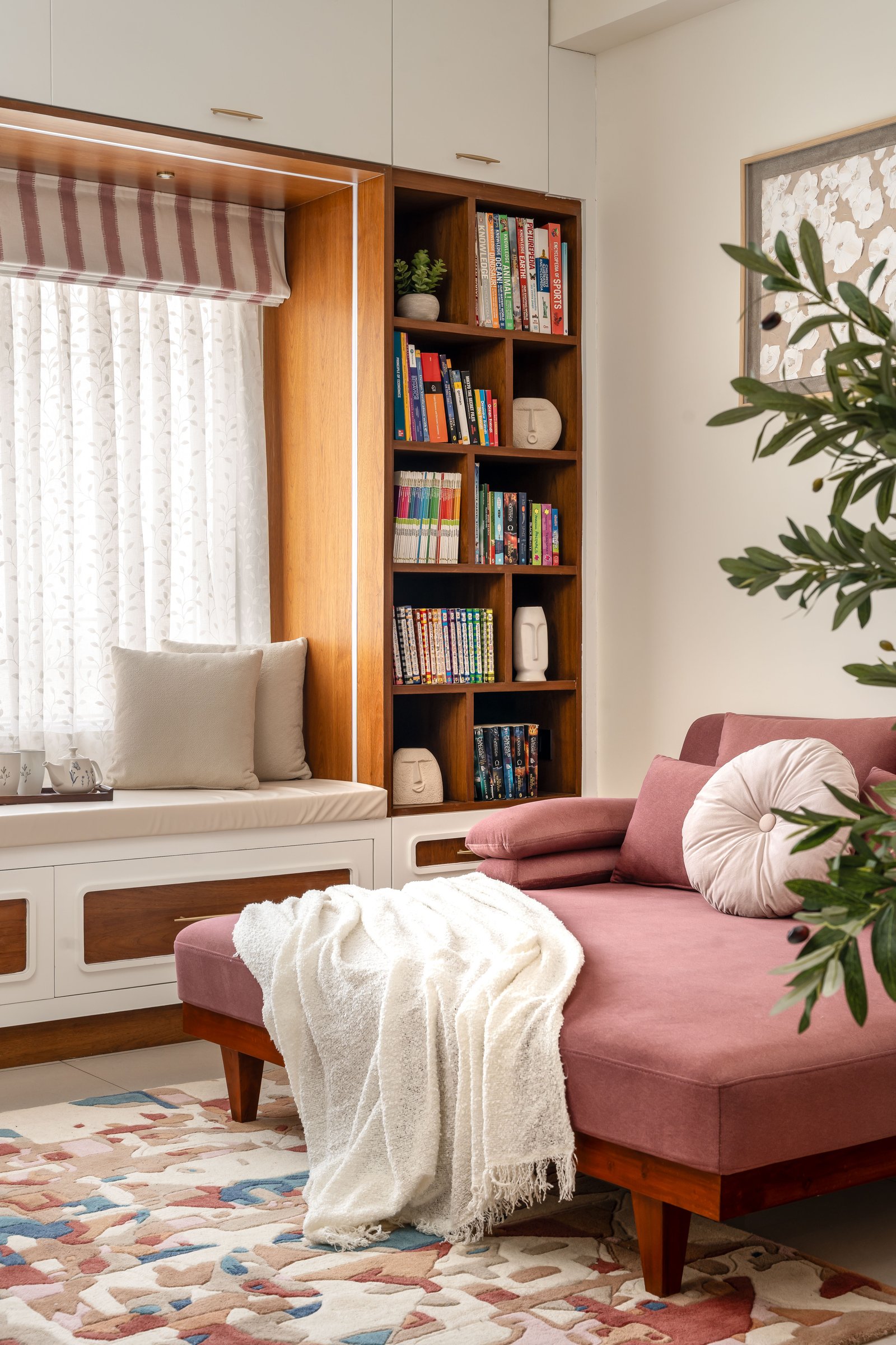A closer view of the nook, where warm wood back-panelling and a tufted rug ground the shared retreat