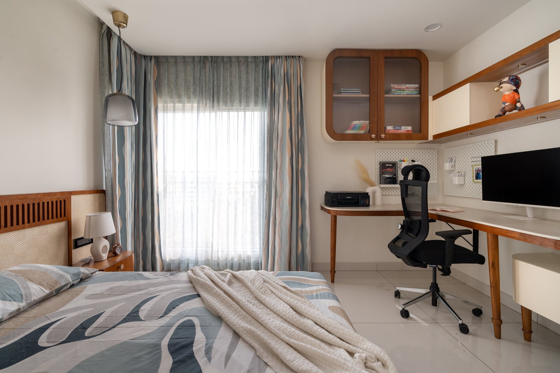 The teenage retreat, where a slatted teak headboard anchors a room shared with a working desk
