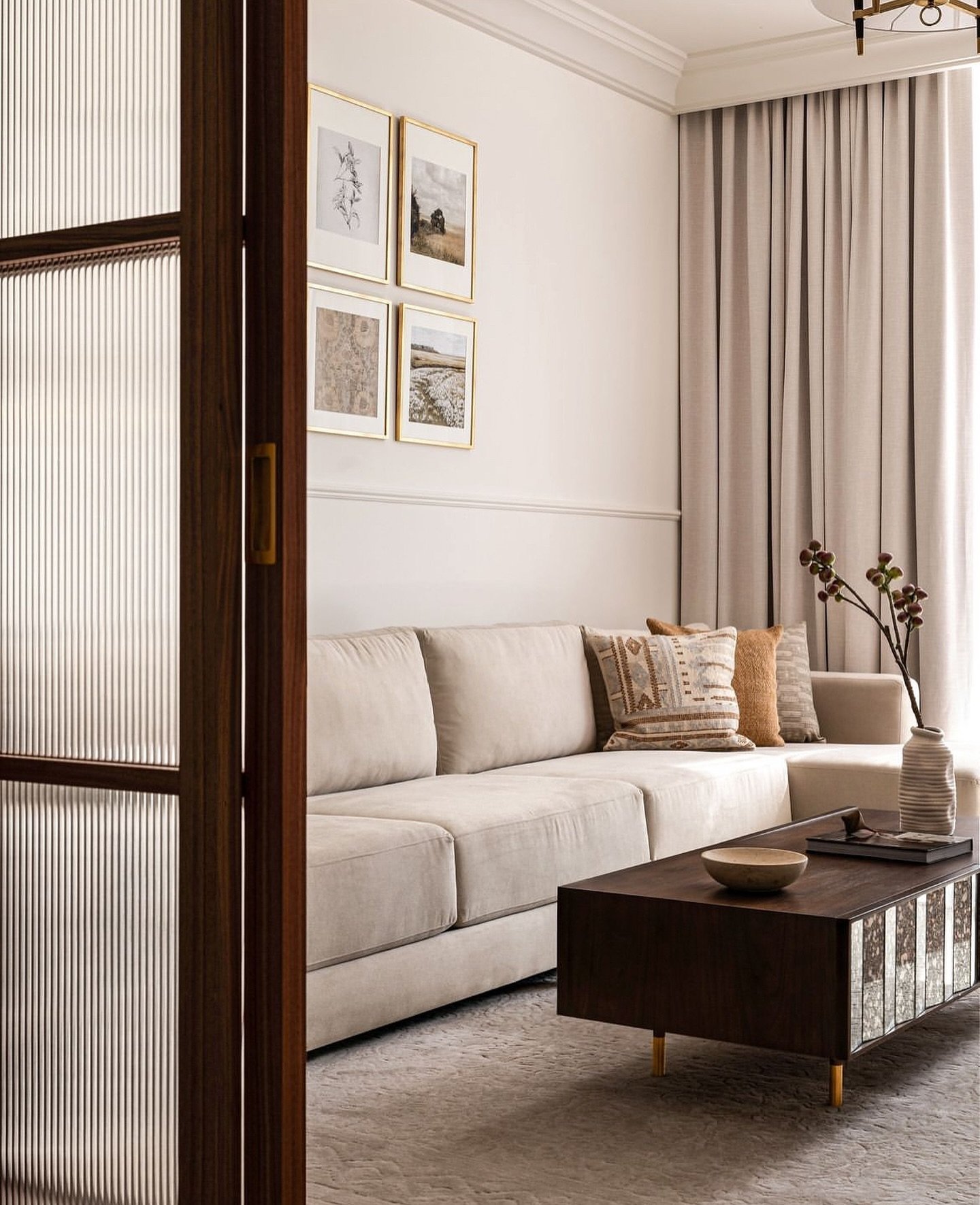 A view through the reeded glass door into a second, quieter living zone.